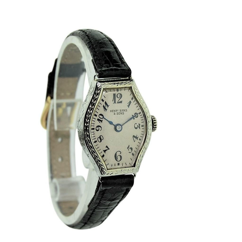 FACTORY / HOUSE:  Birks and Son
STYLE / REFERENCE: Art Deco / Hand Engraved / Tortue Shaped
METAL / MATERIAL: 18Kt. White Gold
DIMENSIONS: 29mm X 21mm
CIRCA: 1930's
MOVEMENT / CALIBER: Manual Winding / 15 Jewels
DIAL / HANDS: Silvered with Enamel