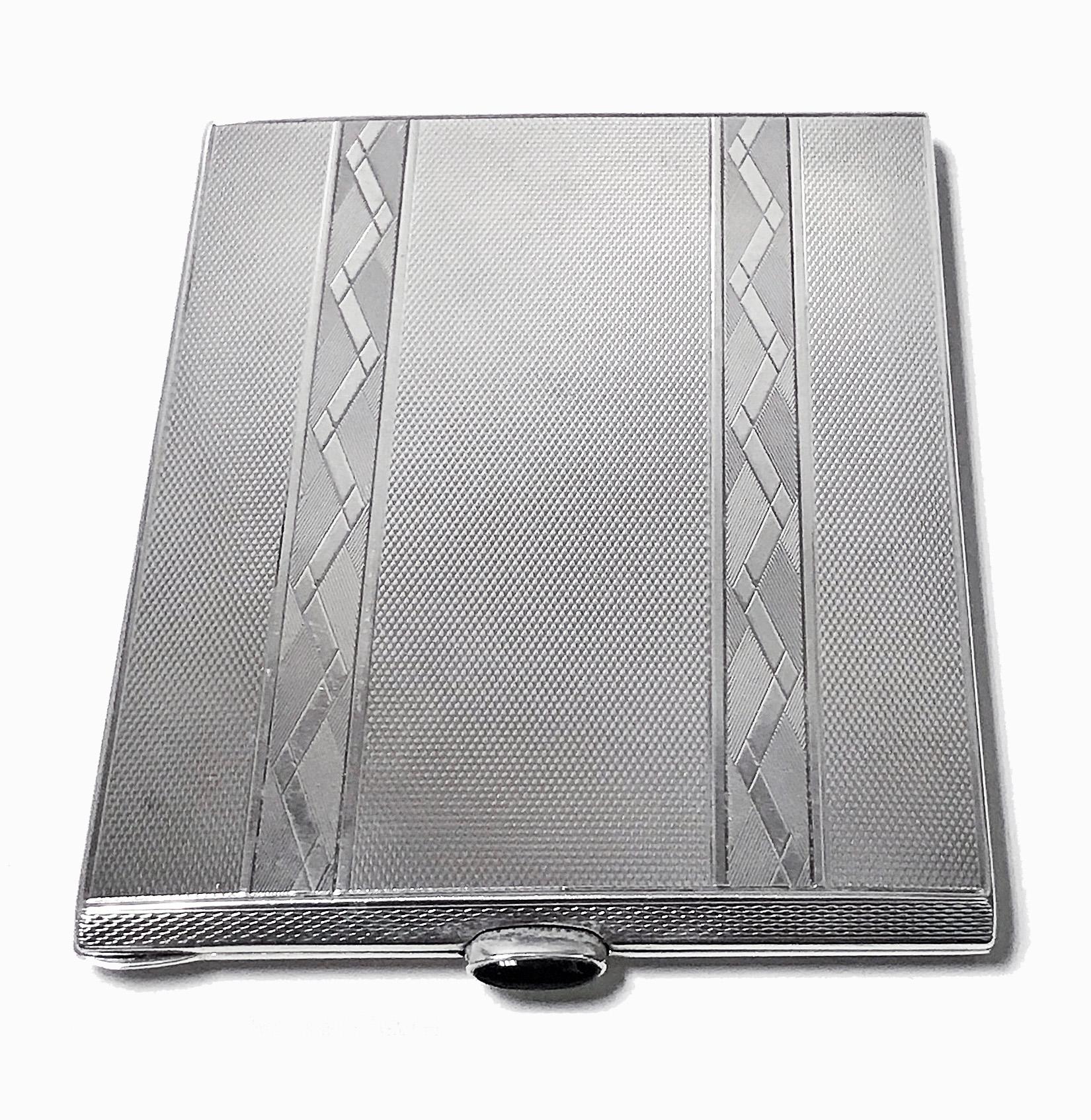 Striking Birks Art Deco Sterling Cigarette or Card Case C.1930. Rectangular shape with panels of polished and groove diamond like design all on engine turned background, bezel set black onyx thumb piece. Gilded interior with pierced hinged holding