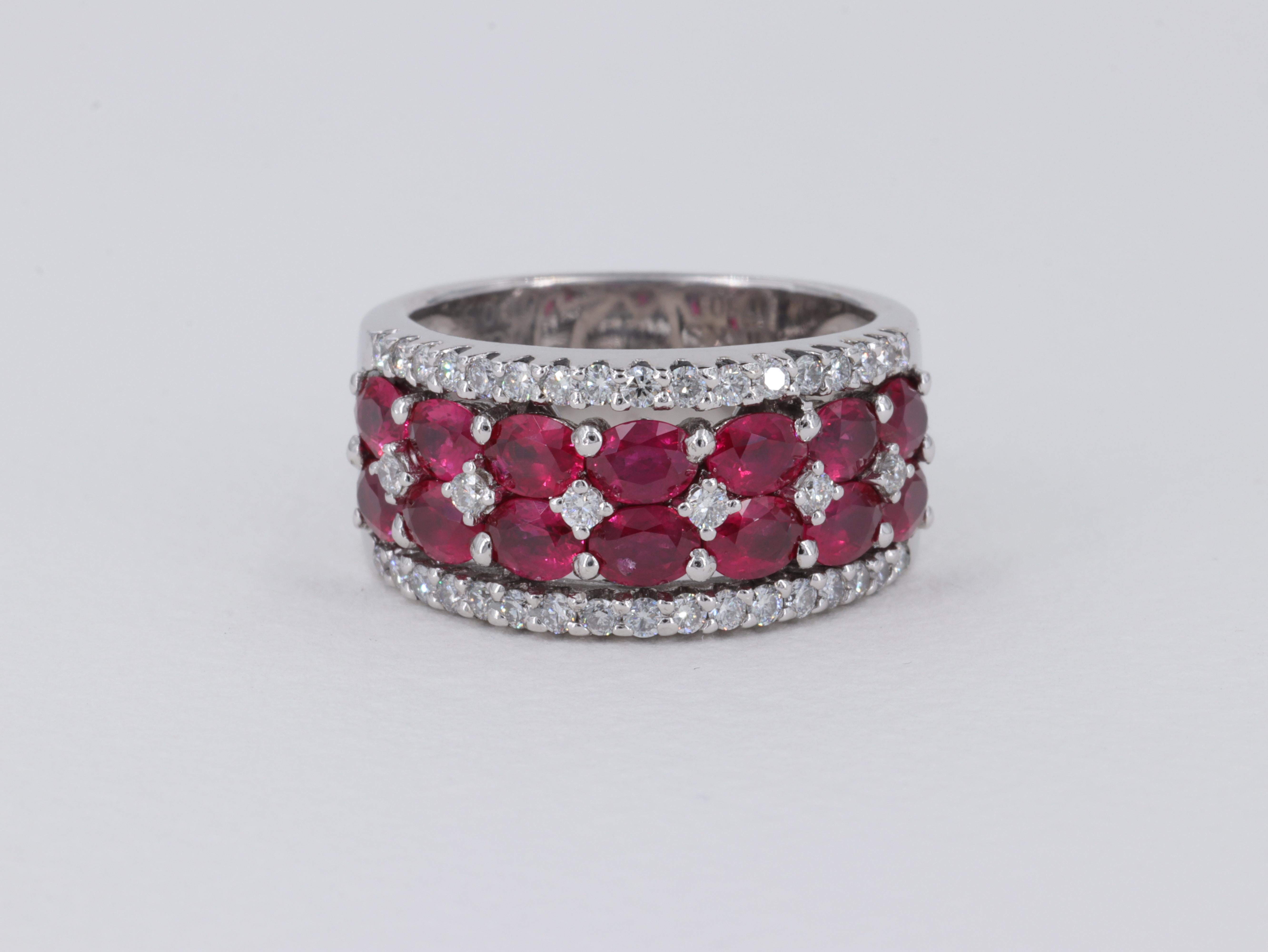 Birks Oval Shaped Natural Ruby and Diamond Wide Band Ring in 18 Karat White Gold
     
Stones: 

Rubies - Natural - 2.85 Carats 
Color - Vivid Red 

Diamonds - 0.55 Carats
Color - F to H 
Clarity - VS1 to VS2 

Ring:

Metal - 18 Karat White
