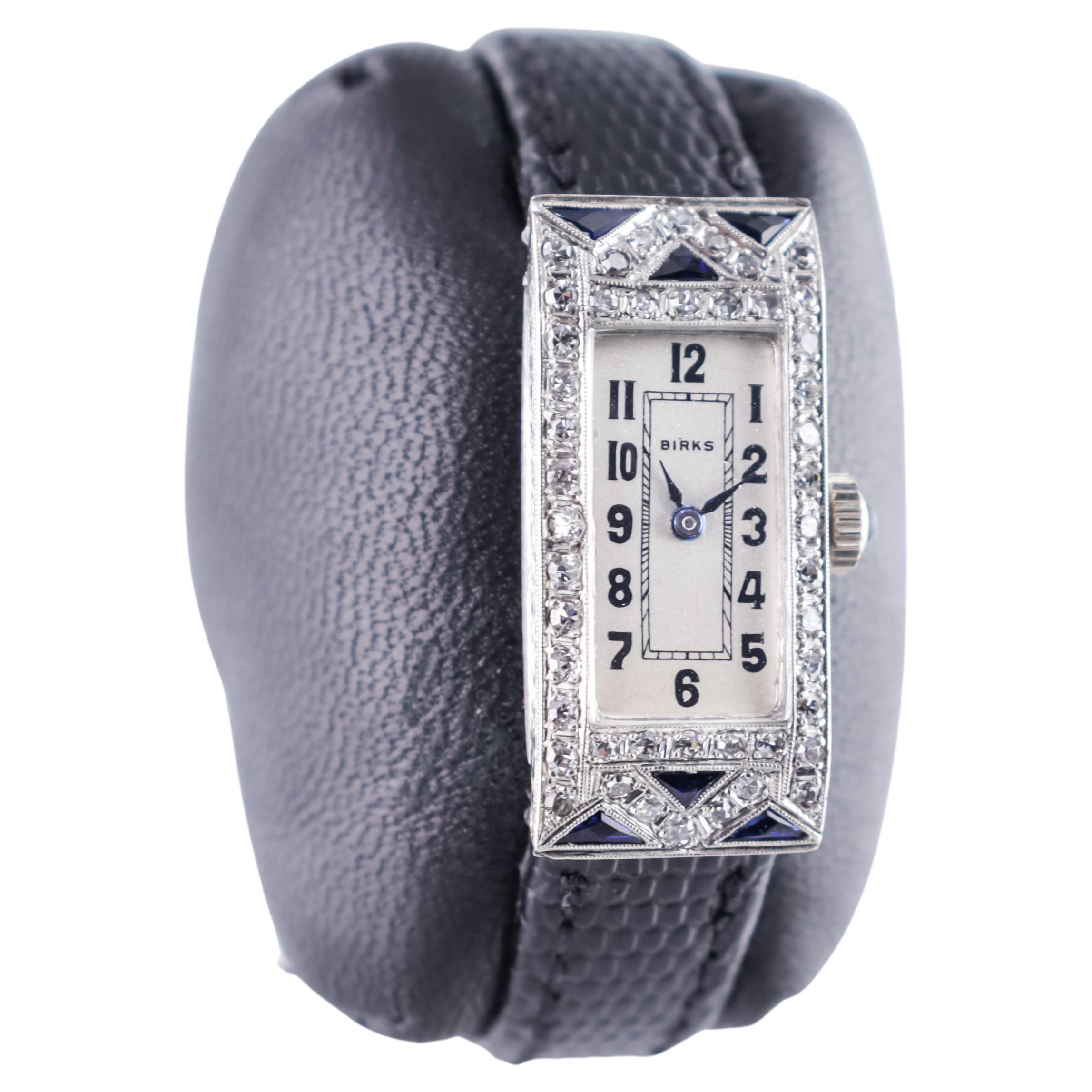 FACTORY / HOUSE: Henry Birks & Sons 
STYLE / REFERENCE: Art Deco Dress Watch
METAL / MATERIAL: Platinum Diamond and Sapphire
CIRCA / YEAR: 1940's
DIMENSIONS / SIZE: 32 Length X 15 Width
MOVEMENT / CALIBER:  Manual Winding / 17 Jewels 
DIAL / HANDS: 