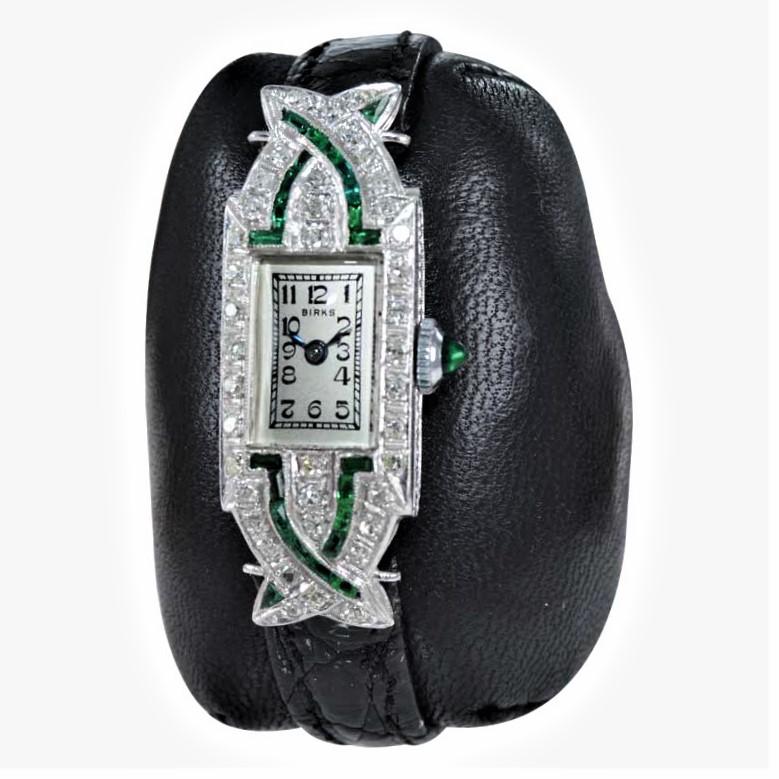FACTORY / HOUSE: Birk's of Canada
STYLE / REFERENCE: Art Deco
METAL / MATERIAL: Platinum / Emerald and Diamond
CIRCA / YEAR: 1930's
DIMENSIONS / SIZE: 40mm X 14mm
MOVEMENT / CALIBER: Manual Winding / 17 Jewels / 5.5 X 8.5 Ligne
DIAL / HANDS: