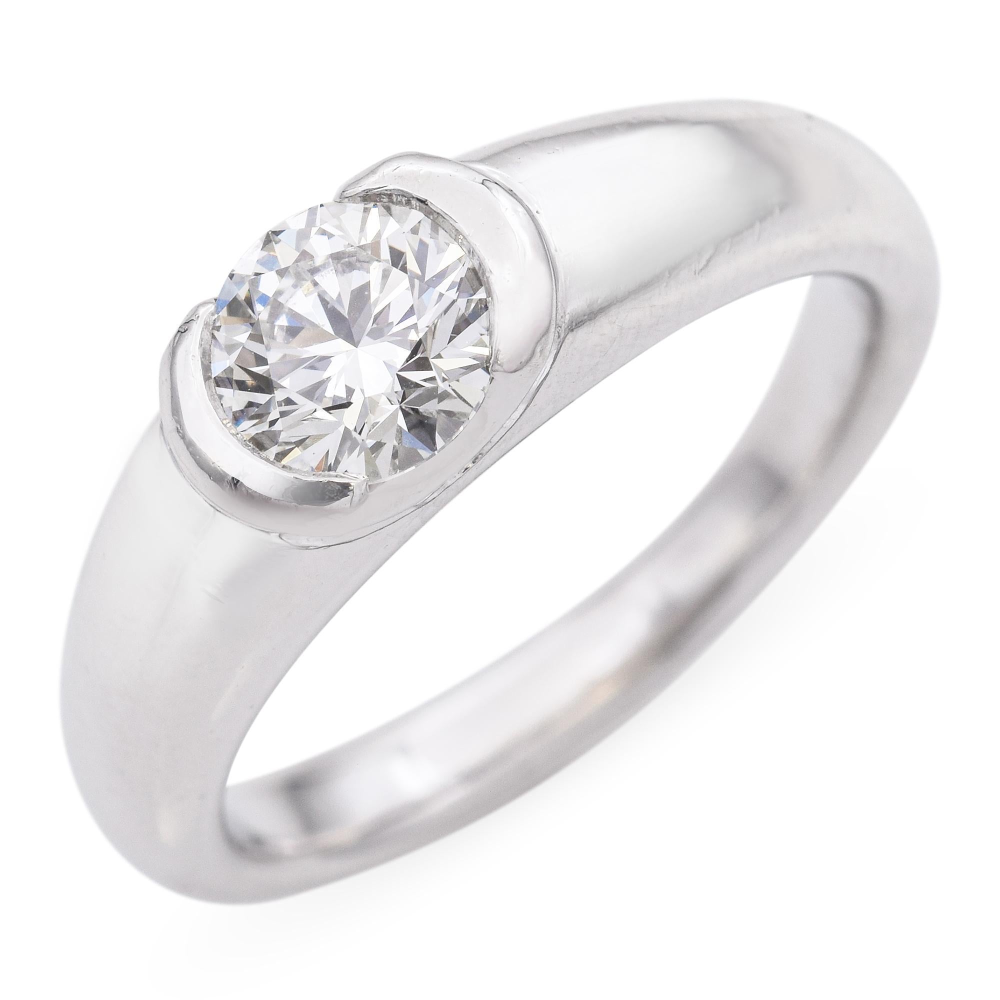 This exquisite piece features a GIA certified 0.72-carat round diamond, showcasing a captivating white hue. The diamond, with a clarity of VS2 and an H color grade, is securely set in a sleek platinum band. The minimalist design highlights the