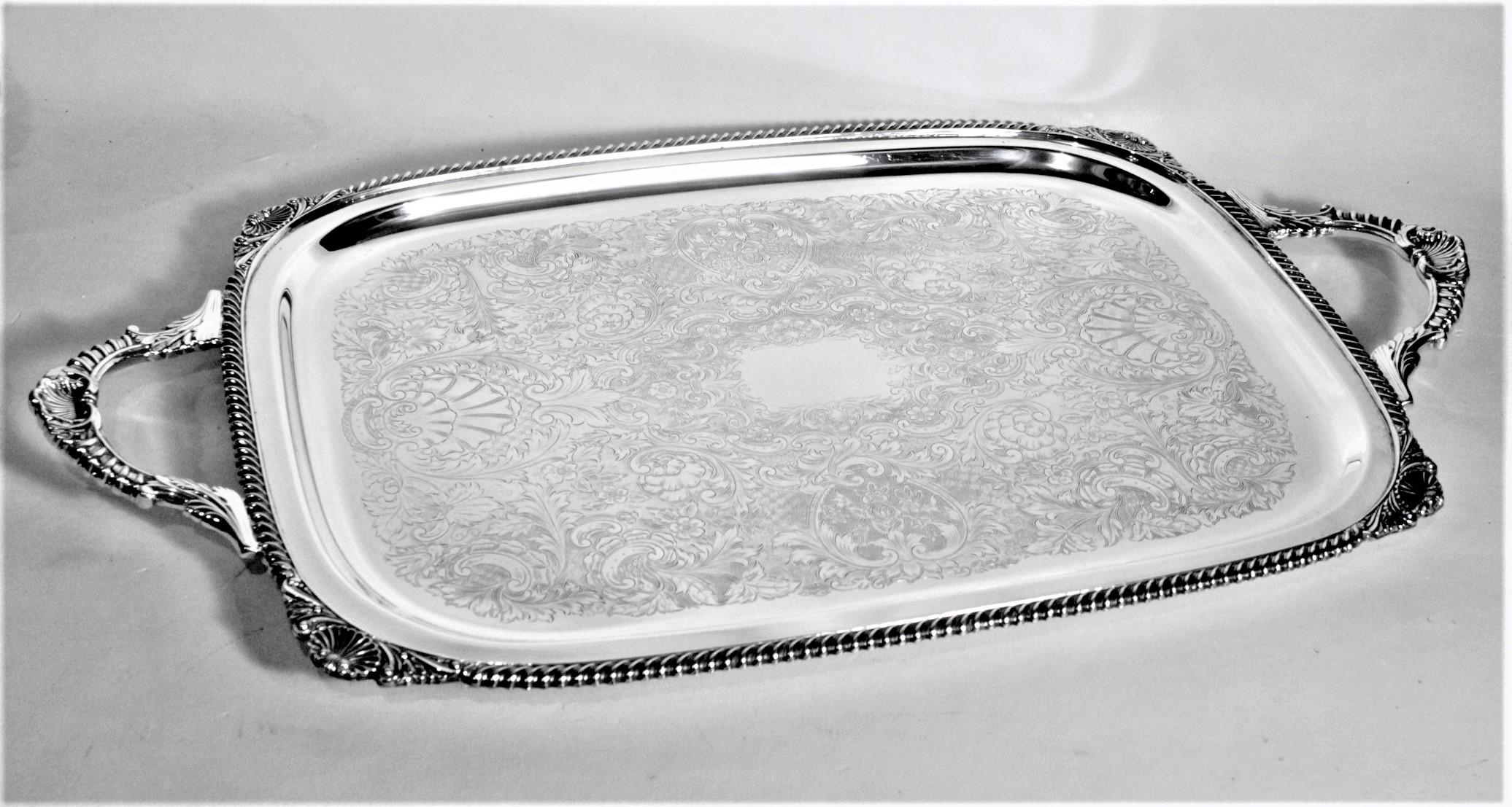 This antique styled silver plated serving tray was made for the well known Birks retailer, likely by an English maker in approximately 1920 in an Edwardian style. This rectangular shaped tray has a very nicely beaded outer surround with