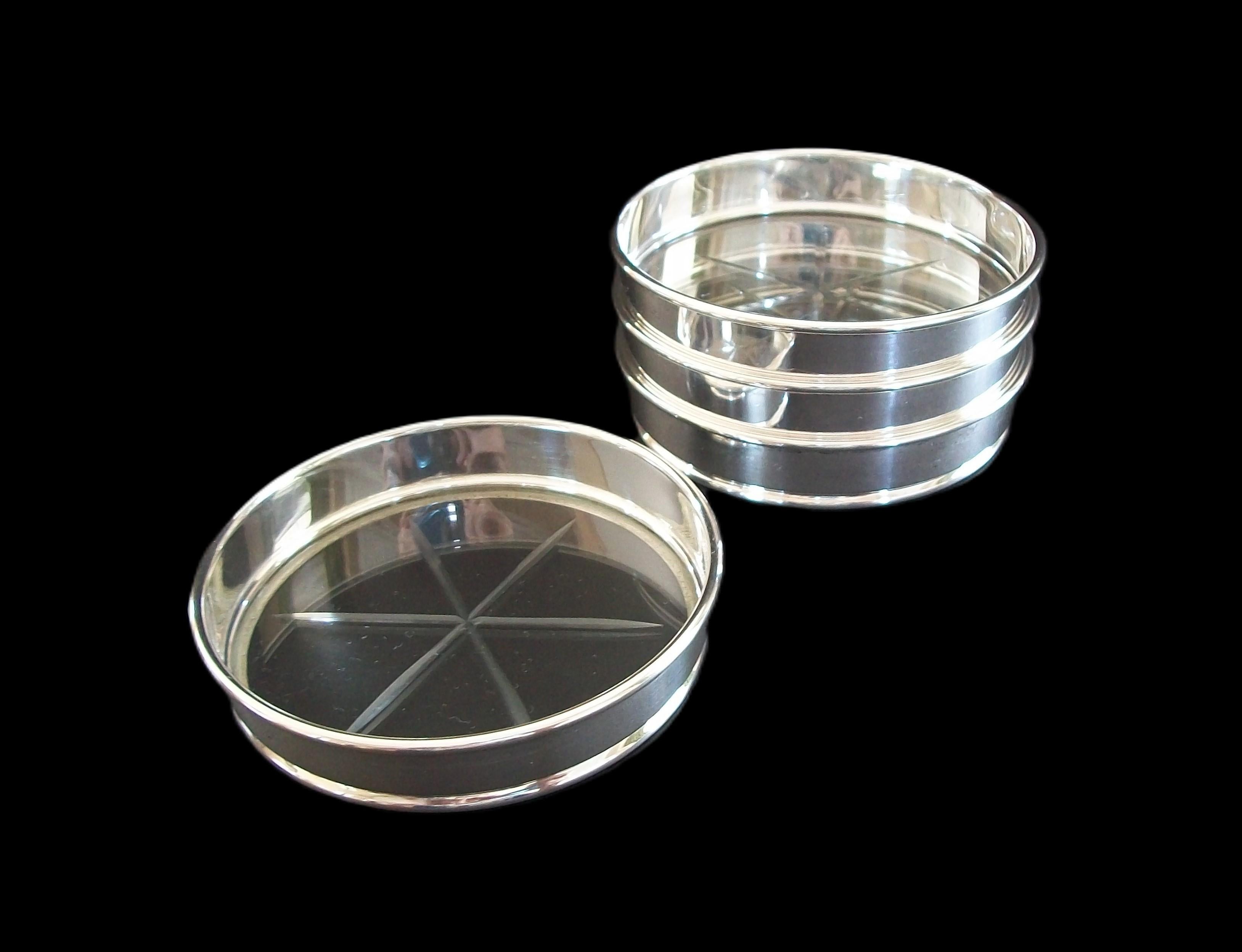 BIRKS - Set of four fine quality sterling silver and cut glass coasters - featuring a stackable design with wheel cut glass inserts - signed BIRKS STERLING on the base of each - Canada (Montreal) - late 20th century.

Excellent vintage condition -