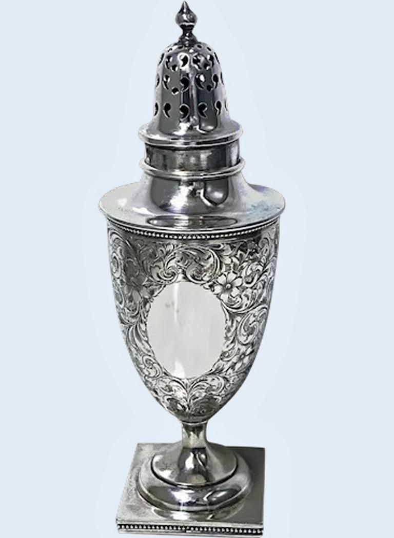 Birks Sterling silver Caster, C.1900. Georgian style, vase shaped on square pedestal foot with bead surround. The body richly engraved foliage decoration and vacant cartouche to one side, detachable pierced cover, plain finial. Birks Sterling