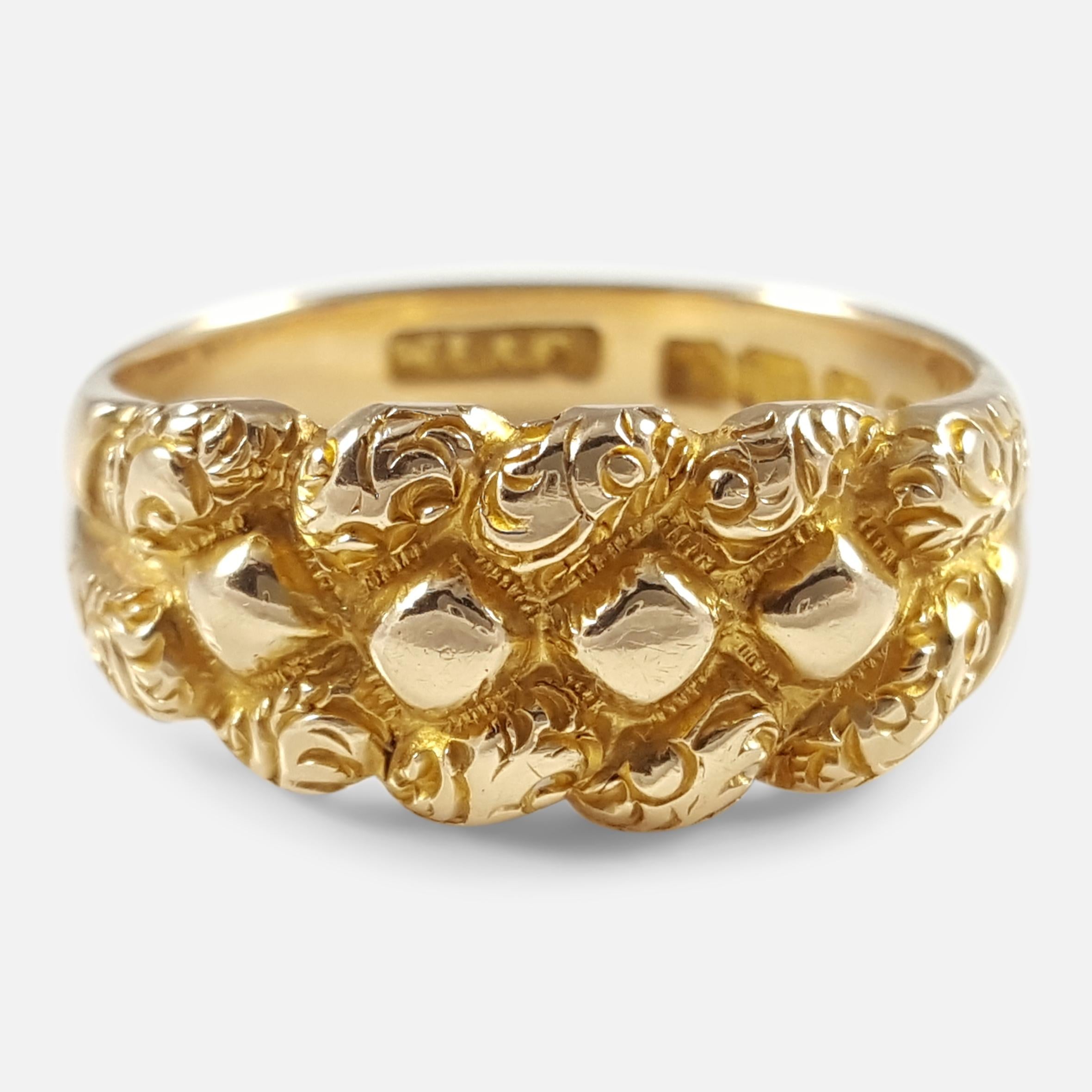 An antique Edwardian 18k yellow gold engraved keeper ring. The ring is fully hallmarked with the Birmingham Assay office stamp, '18' to denote 18 karat (carat) gold, and the date letter 'd', for (1903).

The band is strong and thick at approximately