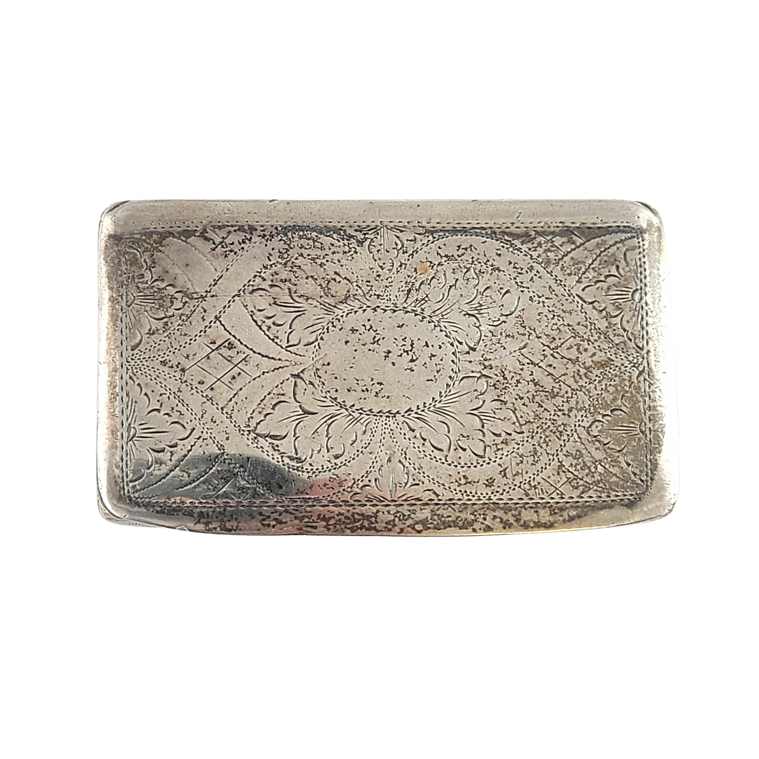 Sterling silver box by Edward Smith of Birmingham, England, circa 1828.

No monogram.

Beautiful small rectangular box featuring an etched design on the hinged lid. A less ornate etched floral design is on the bottom of the box. Gold washed