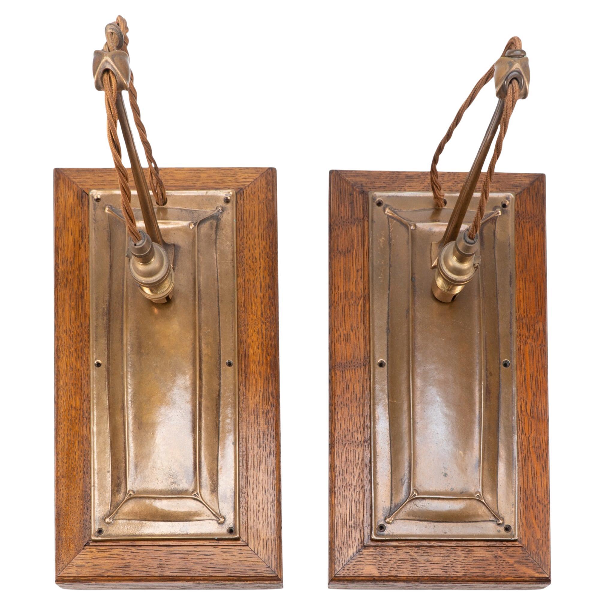 Birmingham Guild of Handicraft. A pair of Arts & Crafts bronze wall lights For Sale