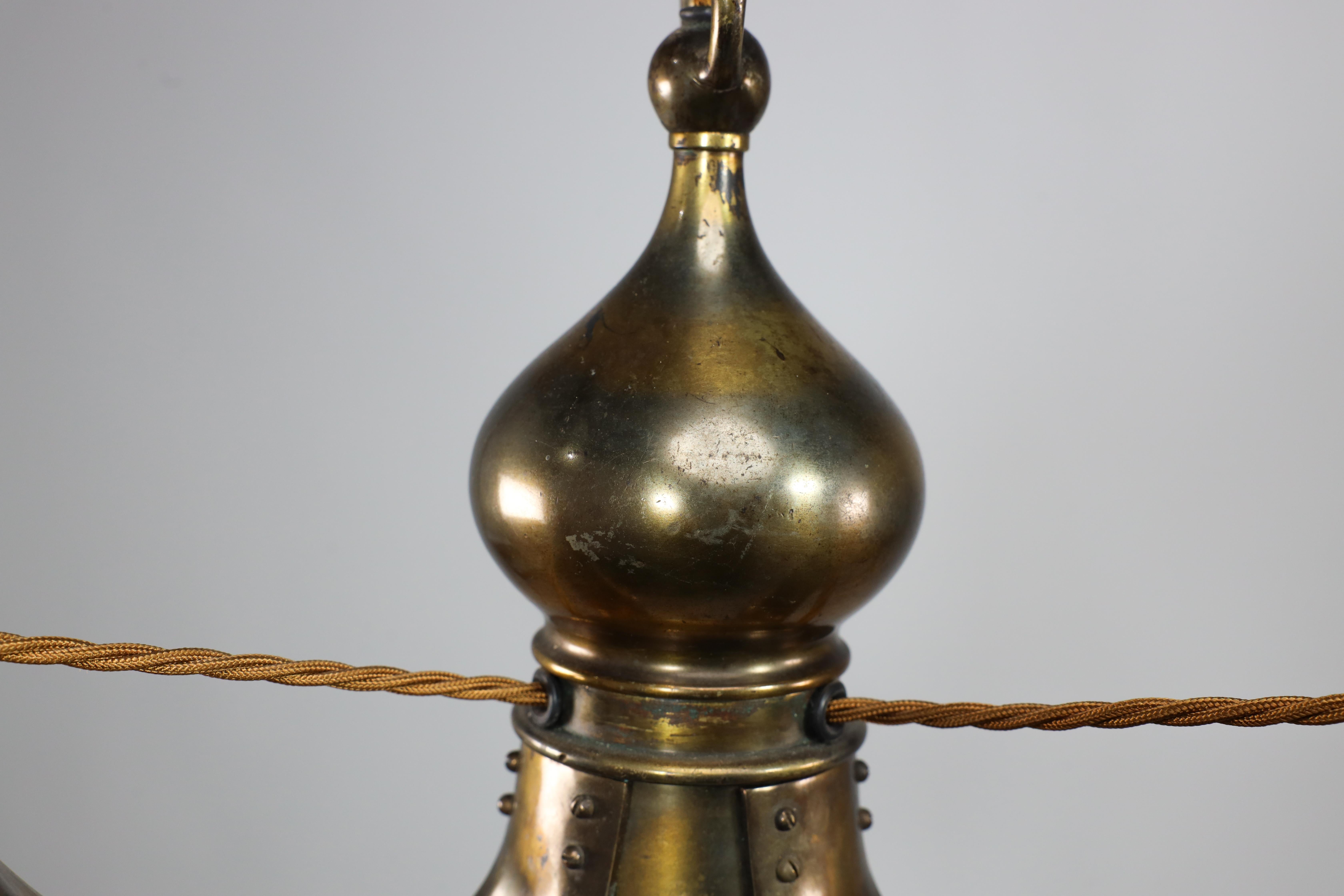 Early 20th Century Birmingham Guild of Handicraft. An Arts and Crafts three arm brass ceiling light For Sale