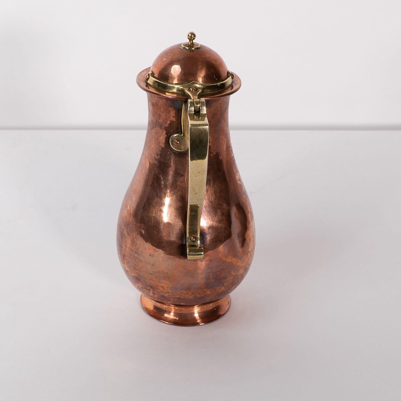 Copper Birmingham Guild of Handicraft. An Arts & Crafts copper and brass chocolate jug For Sale