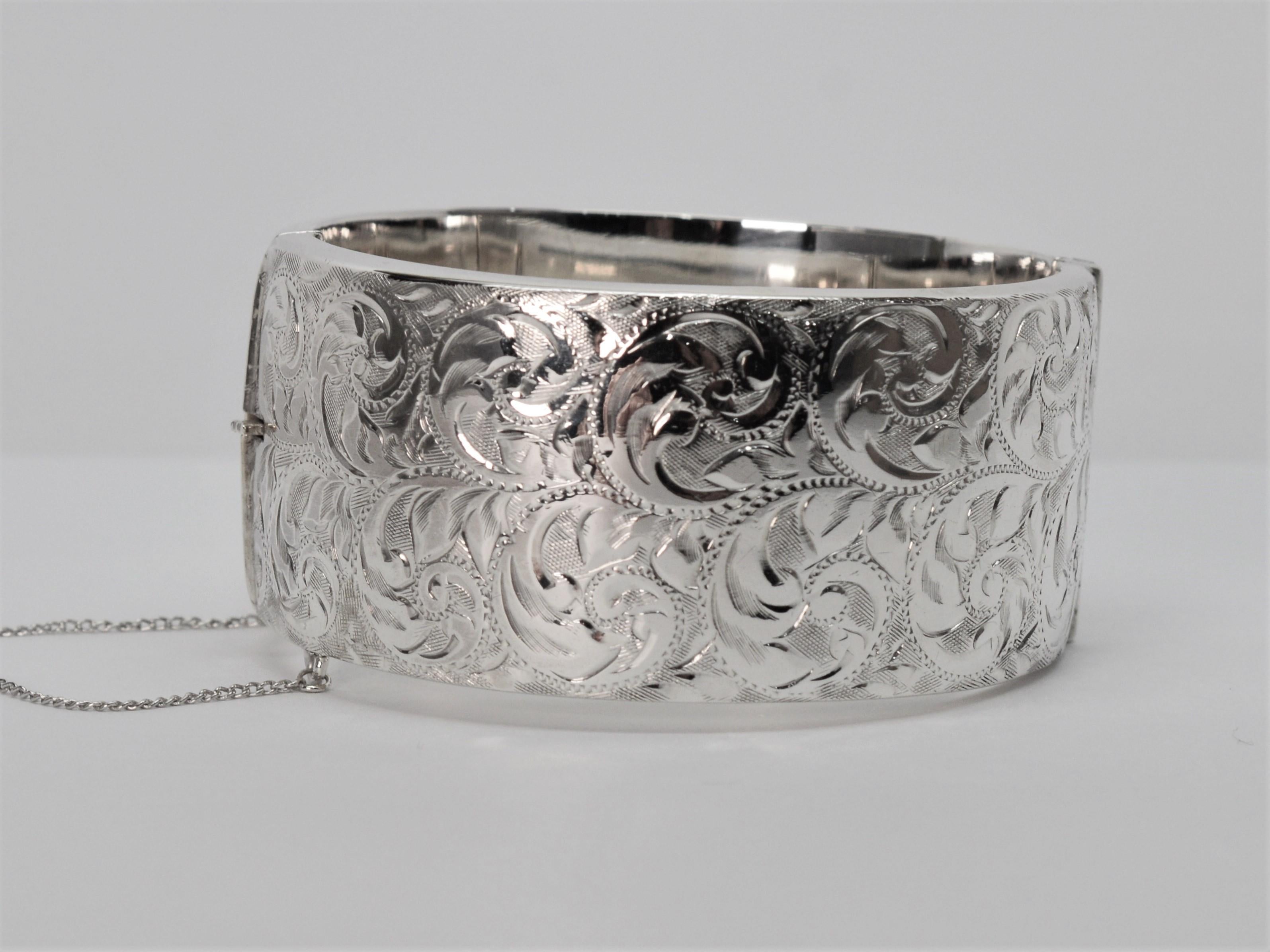 For vintage silver lovers by CPS Jewelry Company, Birmingham, England, this highly polished 1-1/4 inch wide sterling bangle bracelet boldly presents a decorative hand engraved pattern design on it's face and a smoothly finished back. To determine