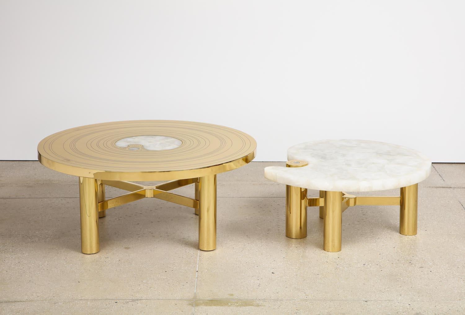 Polished brass, quartz.  2pc nest with larger table featuring incised brass top and inset quartz center.   Lower table with slab quartz top.  15-20 weeks lead time.
h. 16.75” / 14”   Diam. 39” / 31.5”     Extended length with one table nested