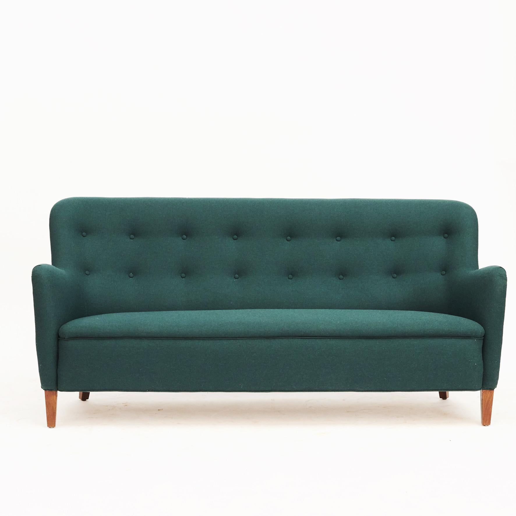 A living room set including a three-seat freestanding sofa and two easy chairs. Designed by Birte Iversen, Denmark, circa 1940-1950.
Cabinetmaker A.J. Iversen, Denmark.

Newly upholstered with wool in deep green from Nobilis.
Sold as a set (3
