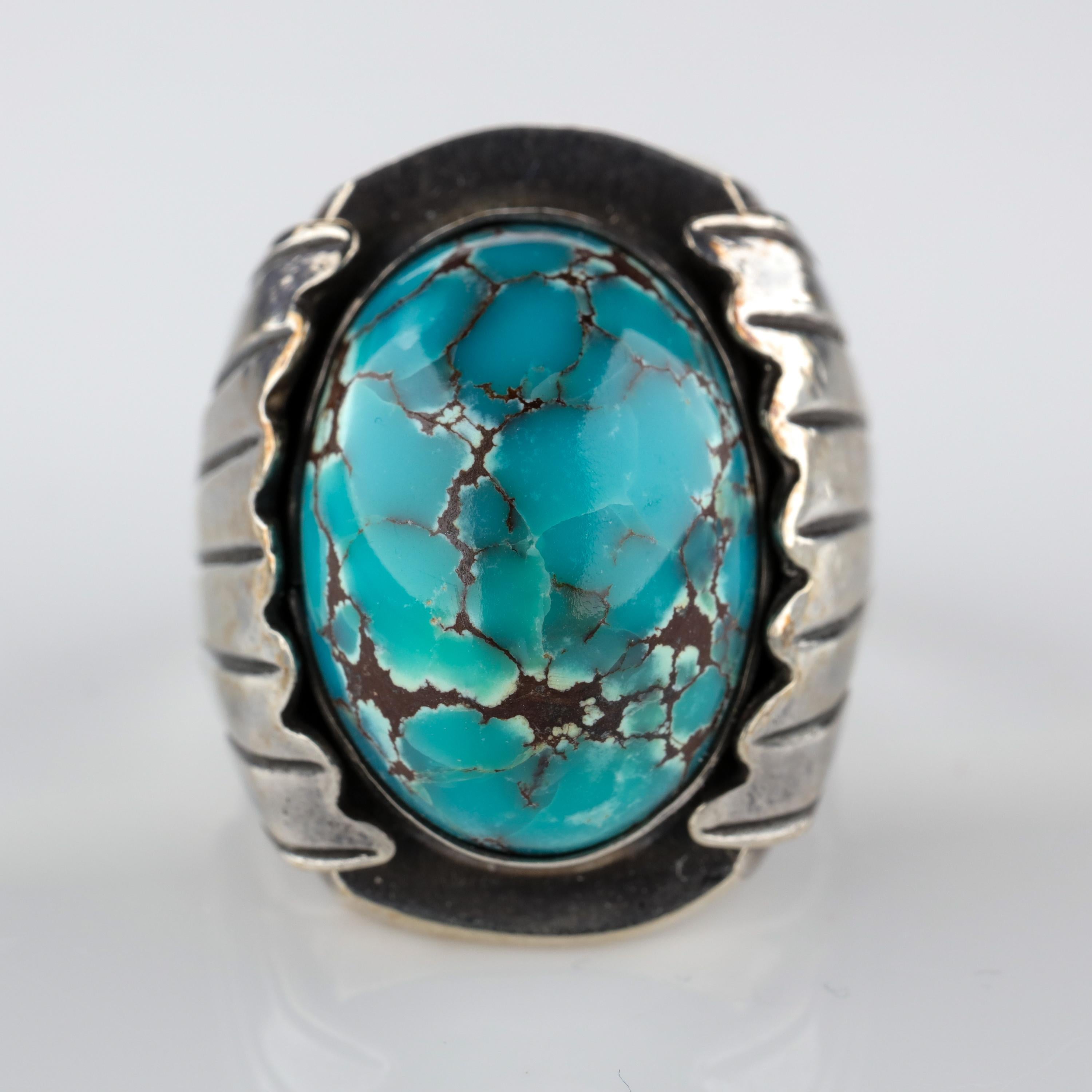 Sky blue with a chocolate-brown matrix, this is an absolutely stunning example of the highly-prized Bisbee turquoise from Arizona. The high-domed stone measures approximately 21.40 mm x 15.92 mm and is bezel-set into a heavy silver mounting with