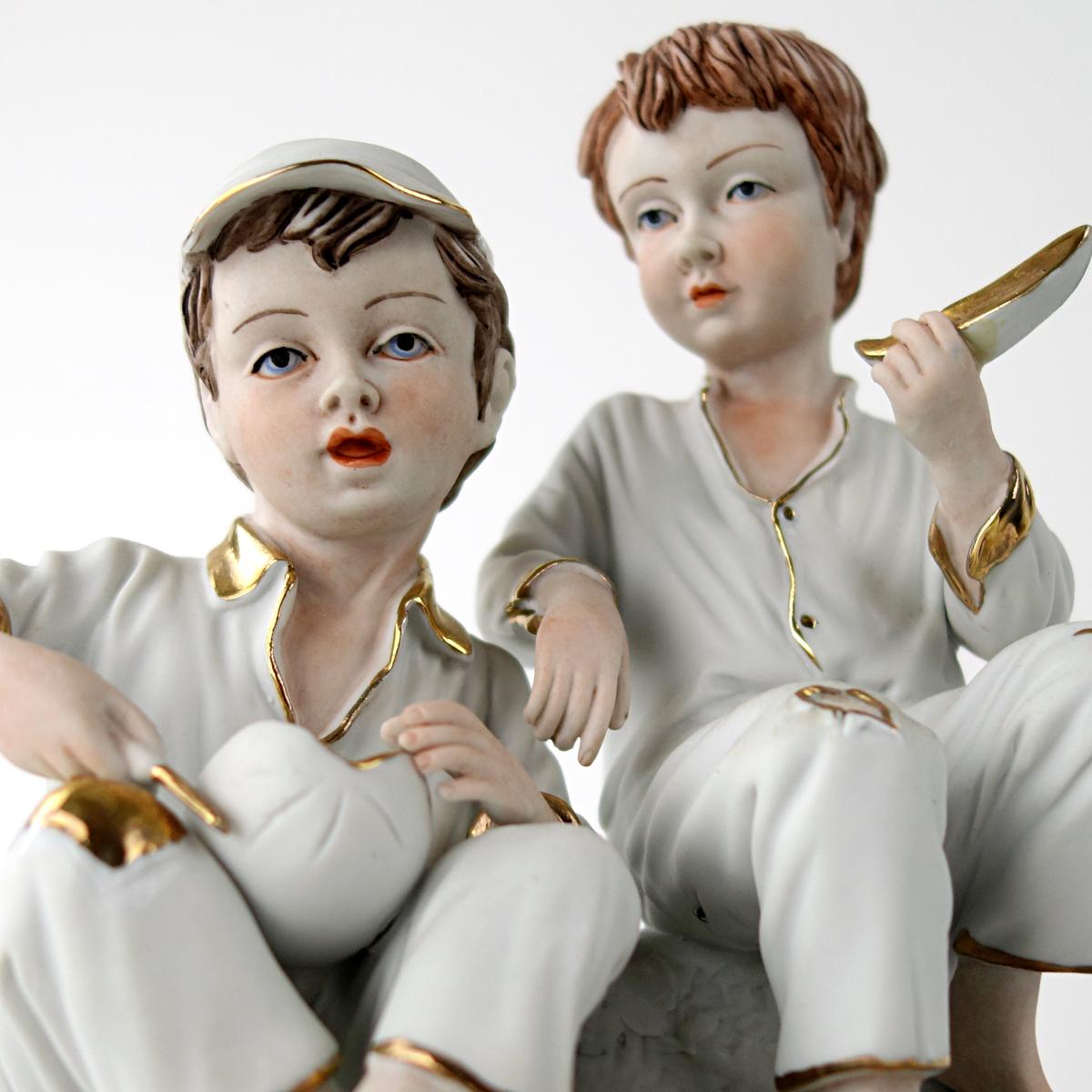 20th Century Biscuit Porcelain Statuette of Two Boys Eating a Melon with Gold-Colored Details For Sale