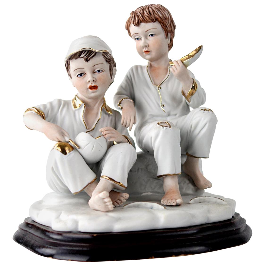 Biscuit Porcelain Statuette of Two Boys Eating a Melon with Gold-Colored Details For Sale