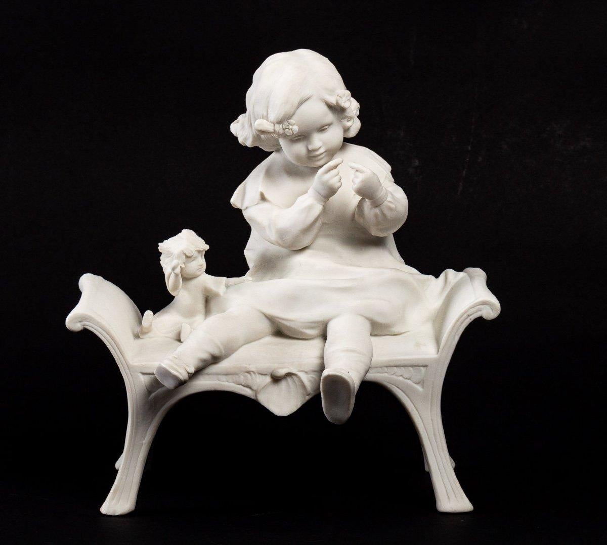 Biscuit statue
Late 19th century.
Beautiful little figurine representing a little girl on a bench with her doll on the side, trying to thread a needle.
Measures: Width : 18 cm
Height : 28 cm
Depth : 21 cm.