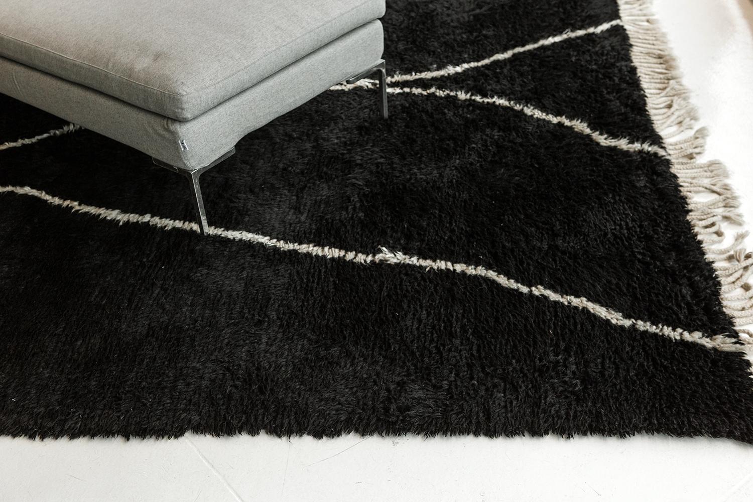 Featuring the soft linear accents running along the plush textured cream field that creates symbolic motifs from the ancient Berber culture. Beautiful tassels complements the overall appeal of this wonderful work of art. This noteworthy rug called