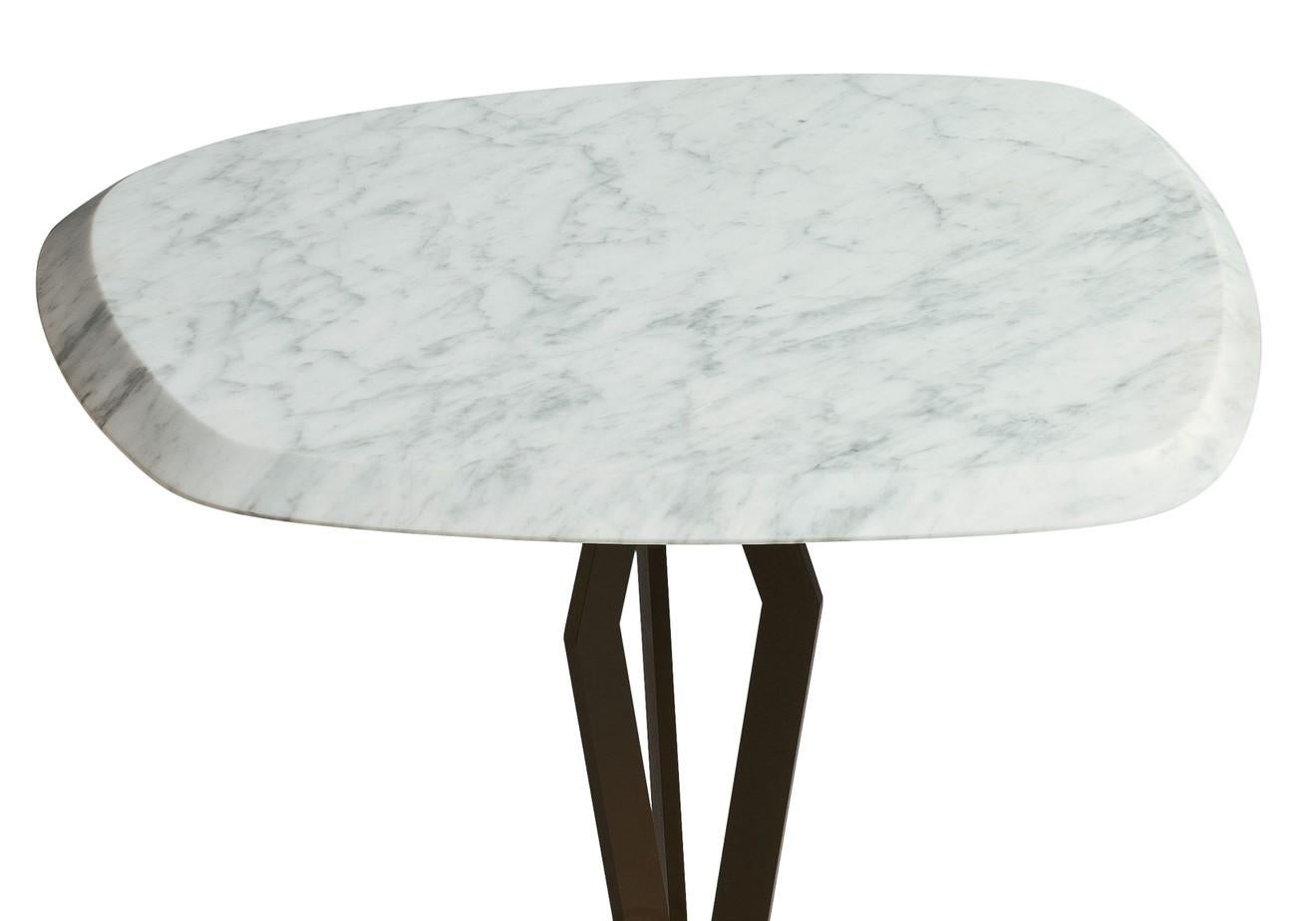 Designed by Paolo Salvadè for MGM, this elegant side table boasts a striking top of Carrara marble, elegantly hand-finished with unique beveled edges. The same precious stone, with its natural decorative veins, makes the square base, both elements