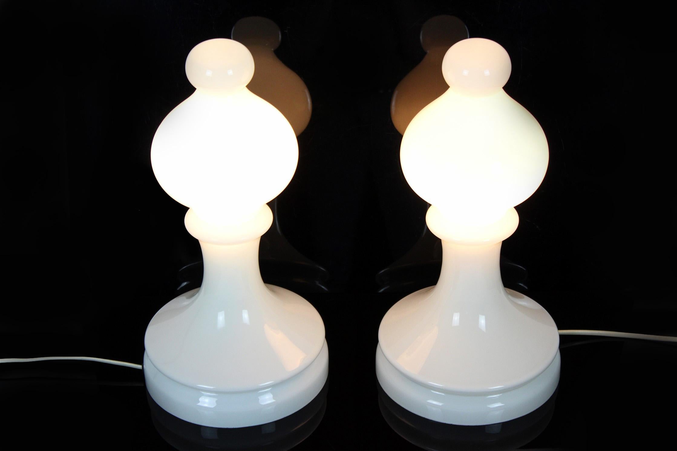 These glass lamps, made of milk white glass in a shape of a chess bishop, were designed by Ivan Jakeš and produced by Osvetlovací Sklo Valašské Mezirící in Czechoslovakia in the 1970s. The lamps are in very good vintage condition, fully functional.
