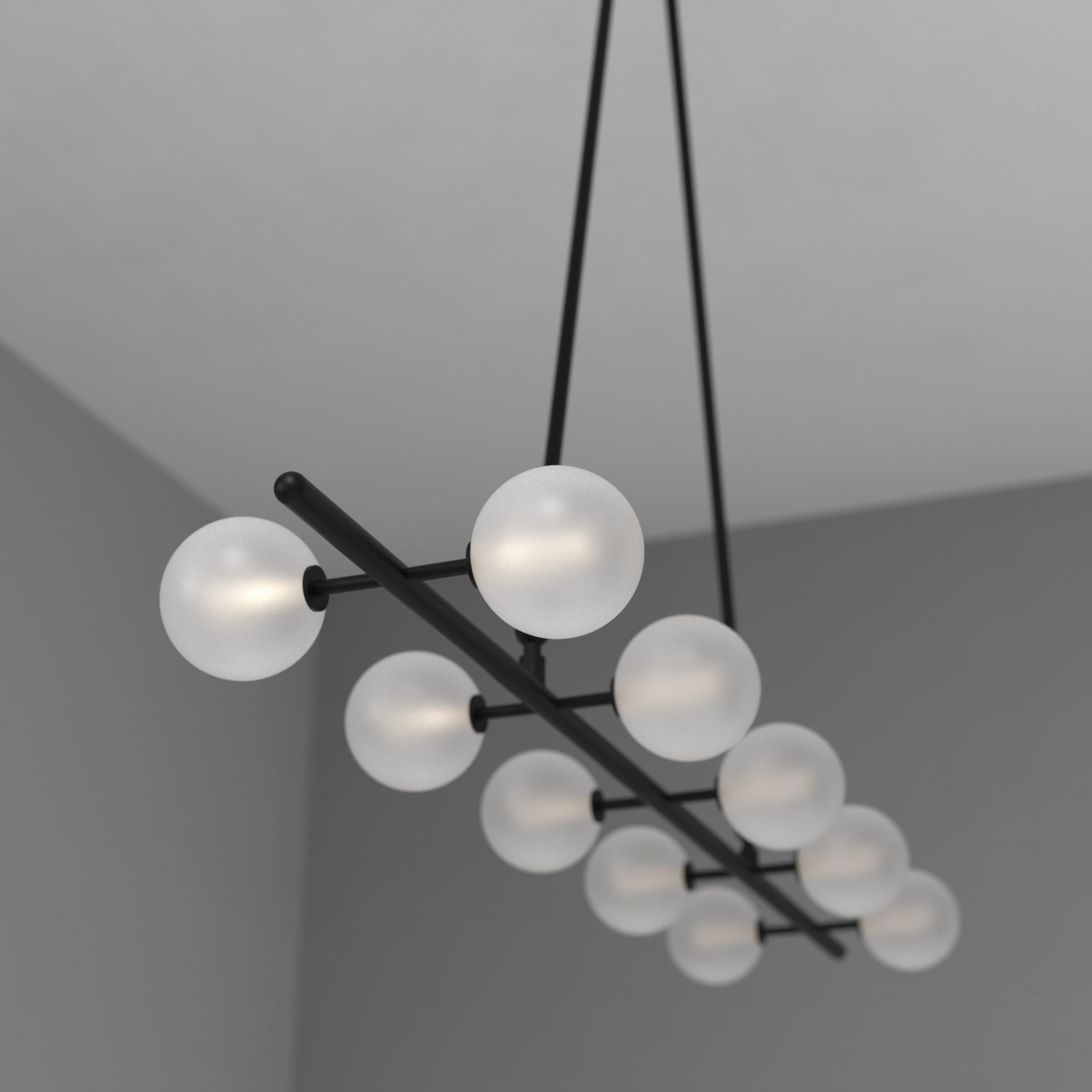 The Bisou Ceiling fixture is a captivating centerpiece that creates a naturally stunning focal point. Its sleek and minimalist frame complements the warm and inviting glow emitted by its ten handcrafted blown glass globes. Designed to compliment our