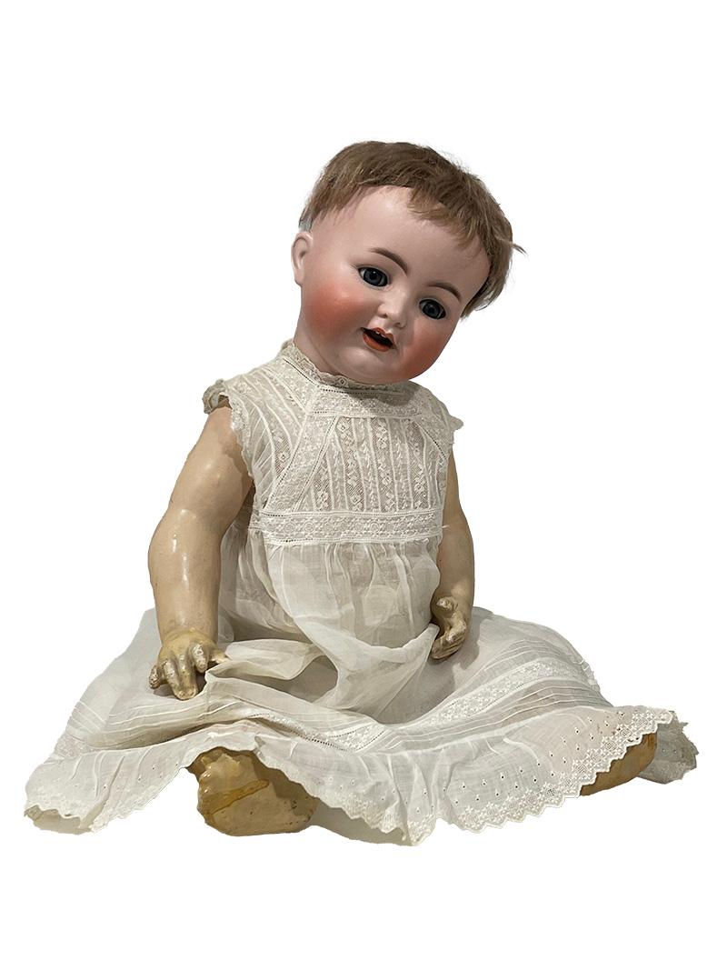 Bisque doll by Simon & Halbig for Kämmer Reinhardt, Germany, ca 1900

A lovely bisque doll of 60 cm long with moving eyes, giving her a flirty look. She wears an antique European lace dress. The hair is cut short. Back of the head fully marked with