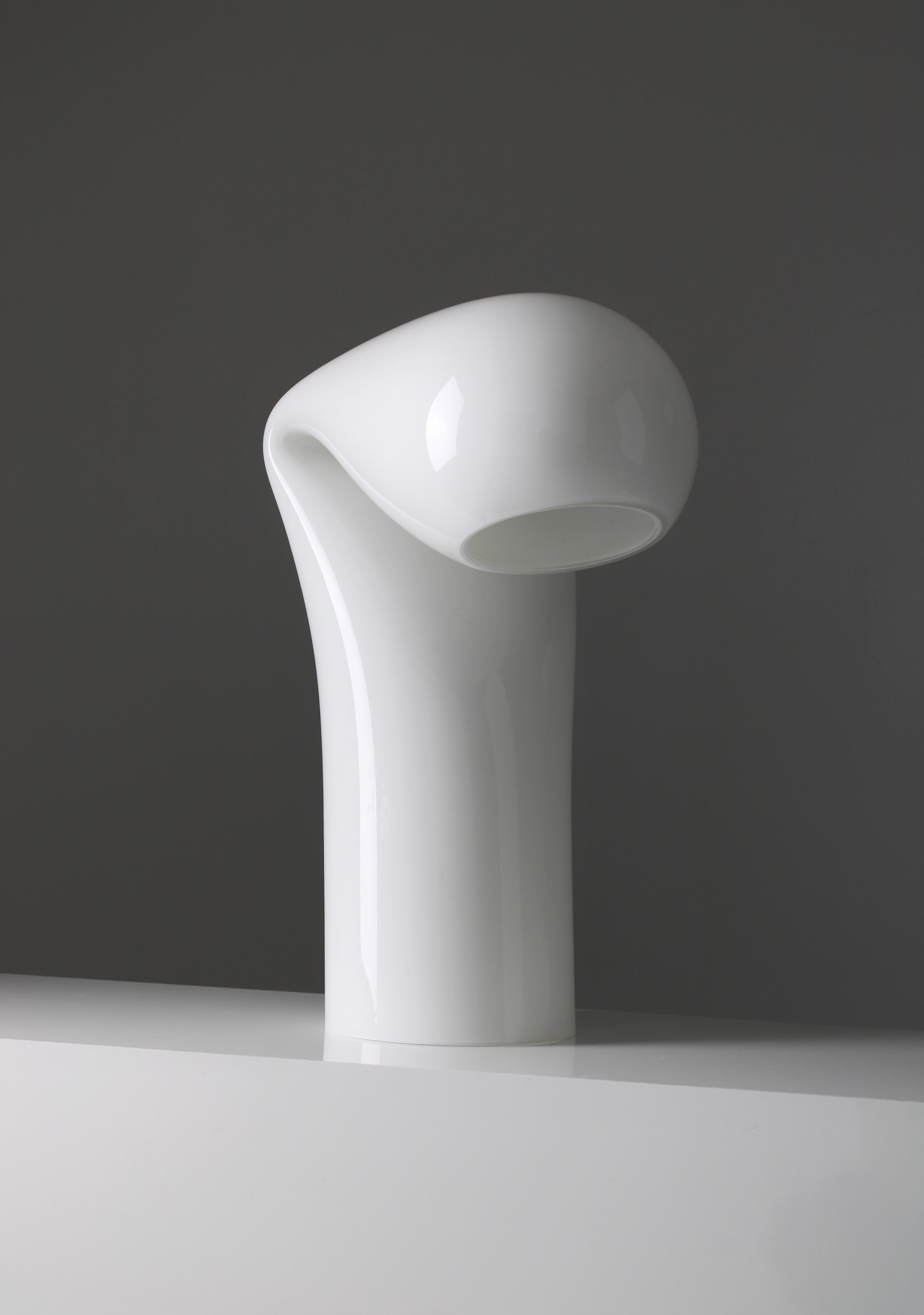 Bissona is a decorative object more than a table light. Designed by Luciano Vistosi for Vistosi in 1968. The cylindrical Murano glass of this lamp gracefully folds over itself like a delicate veil, forming a piece defined by its simplicity and