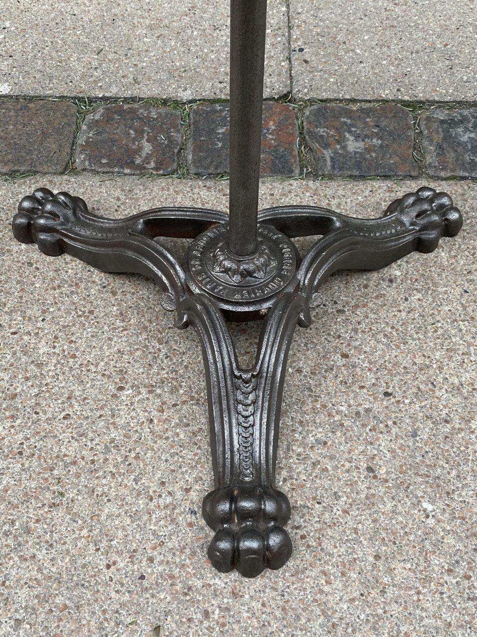 Delightful rustic vintage round French bistro or café table. Gorgeous cast iron Art Deco style, from circa 1920s. Note the beautiful three footed lions claw base. Stamped from Paris.

This piece has been deacidified, treated and polished to a raw