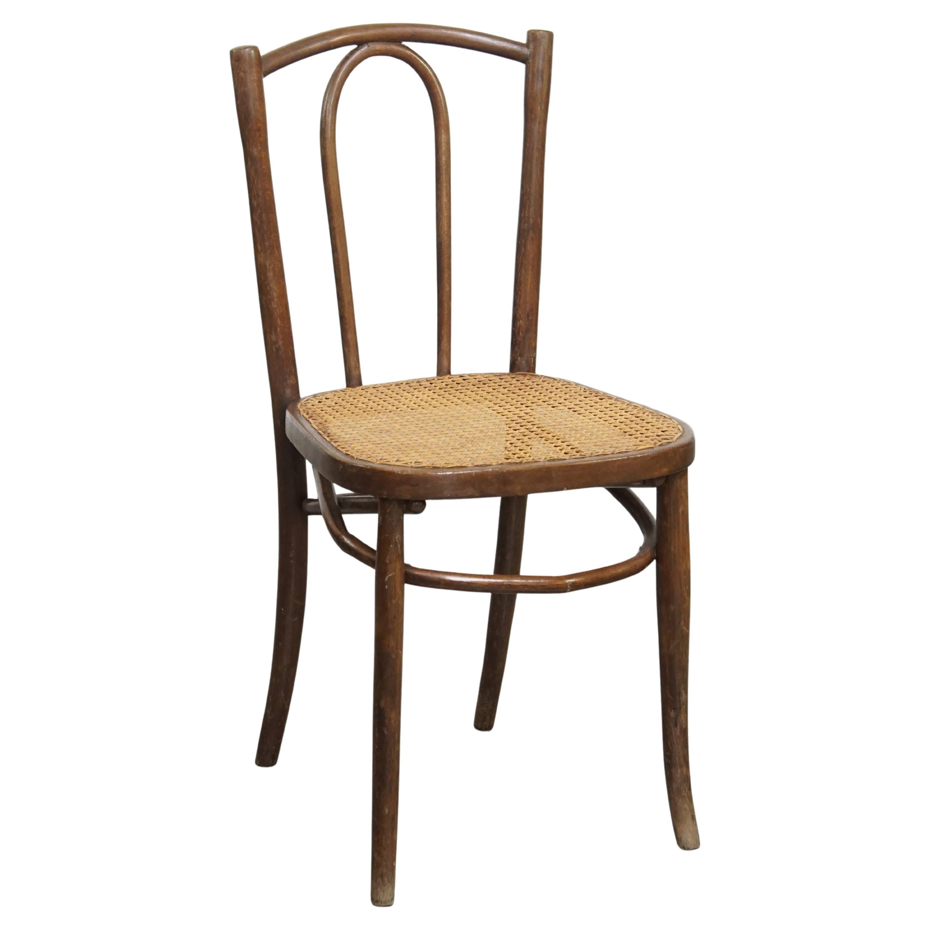 Bistro chair with a woven cane seat For Sale