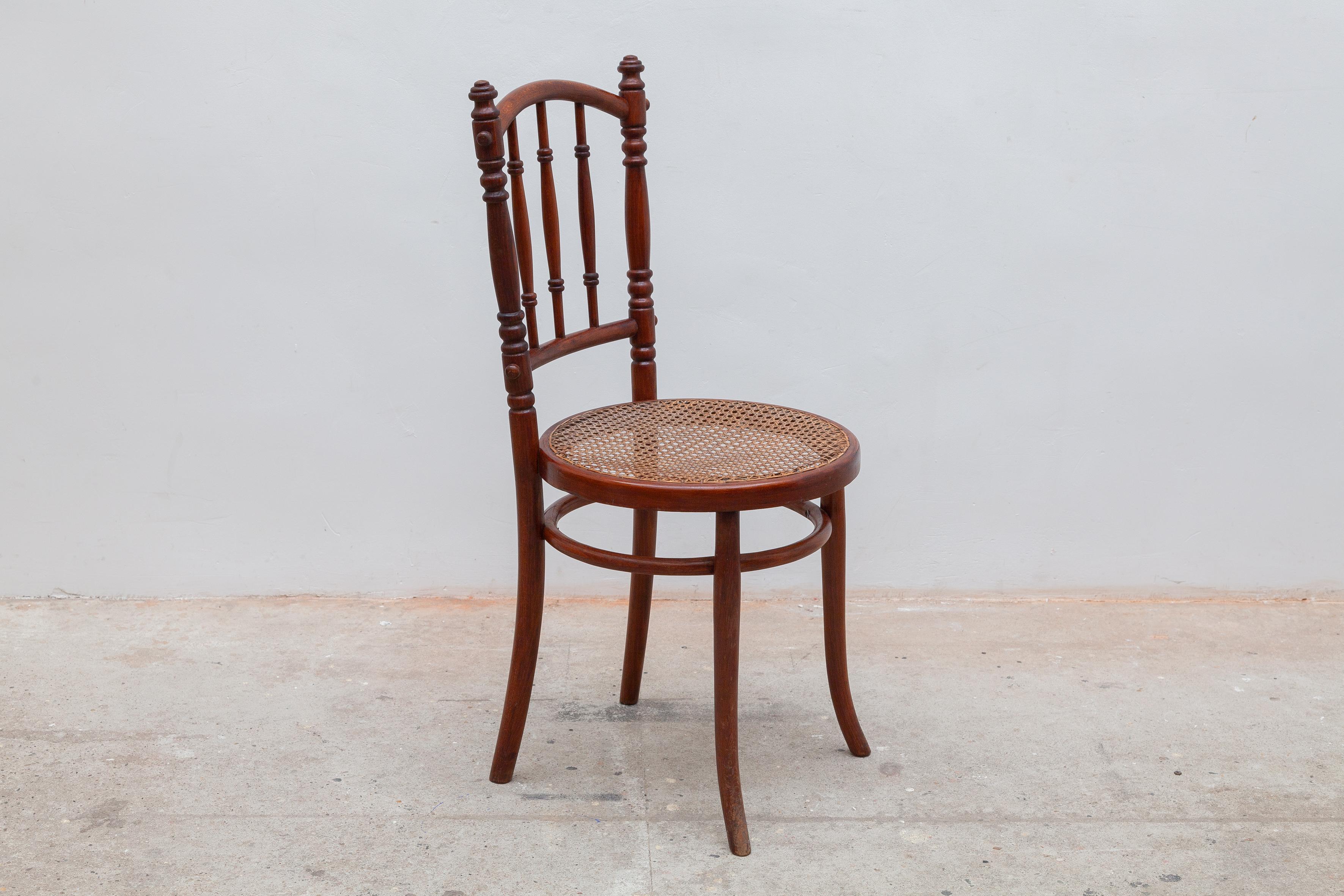 Classic collectible chair by famous German-Austrian cabinetmaker Michael Thonet. Turned spindle wood frame with caned seat. The caning is in need of restoration.
Dimensions: 42 W x 93 H x 42 D cm seat: 47 cm high.