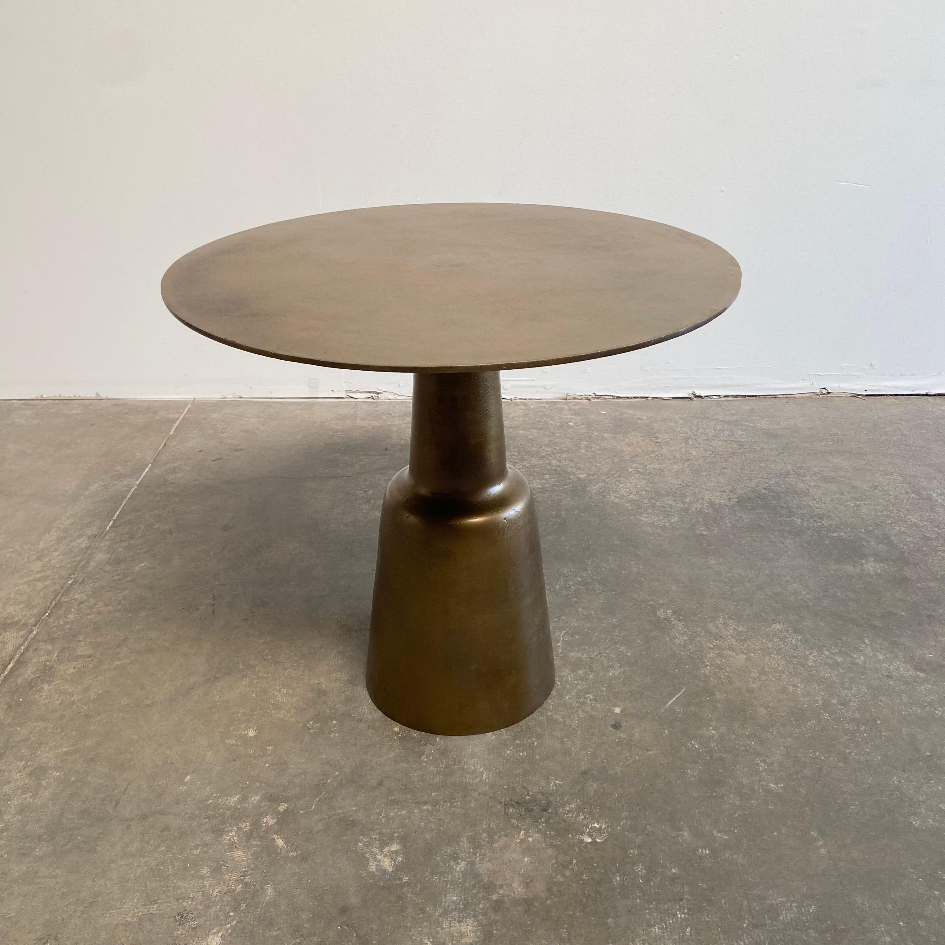 Aged Patina brass finish, this table works well as a bistro table, or use as an entry center table.
The top has a wonderful aged patina, and the finish is of an aged brass.
Size: 31-1/2” RD. X 29” H.
 
