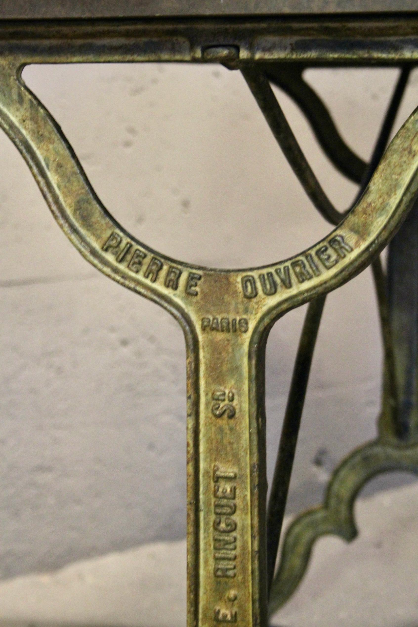 French bistro table with a signed design, Bakelite top, and cast iron base For Sale