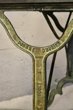bistro table with a signed design, Bakelite top, and cast iron base
