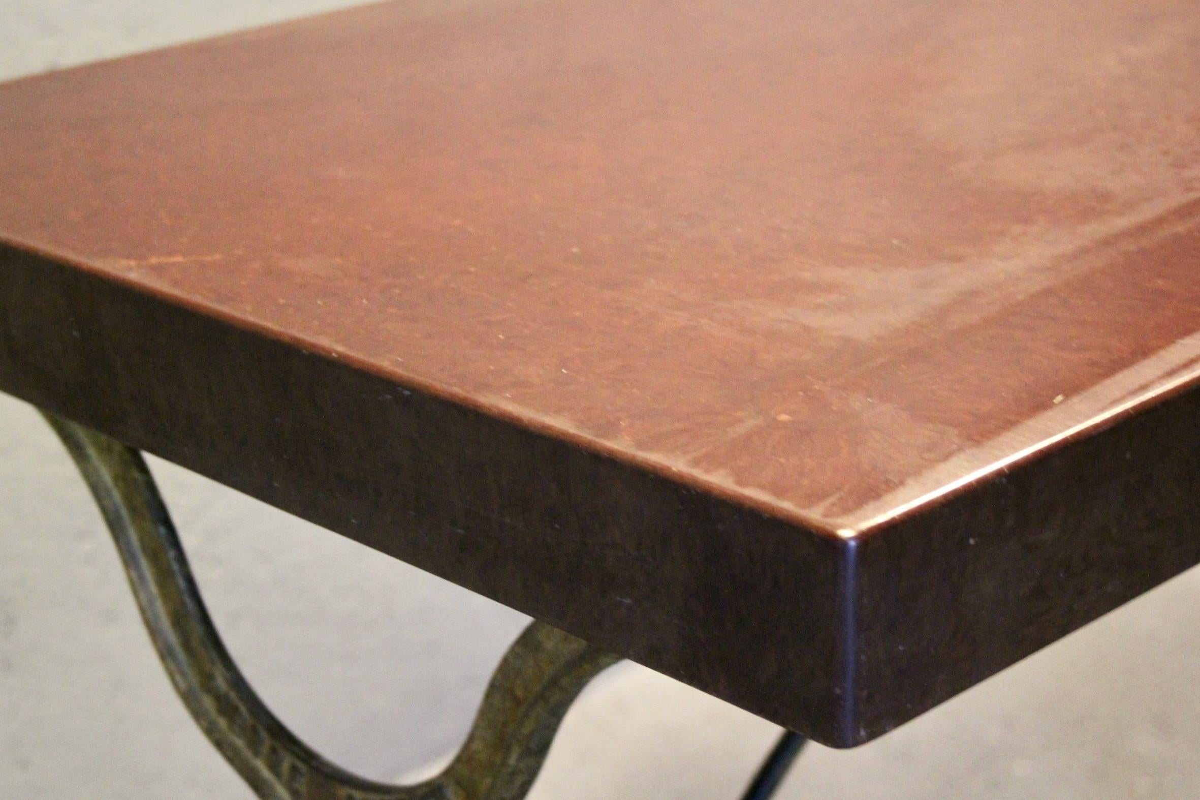Iron bistro table with a signed design, Bakelite top, and cast iron base For Sale