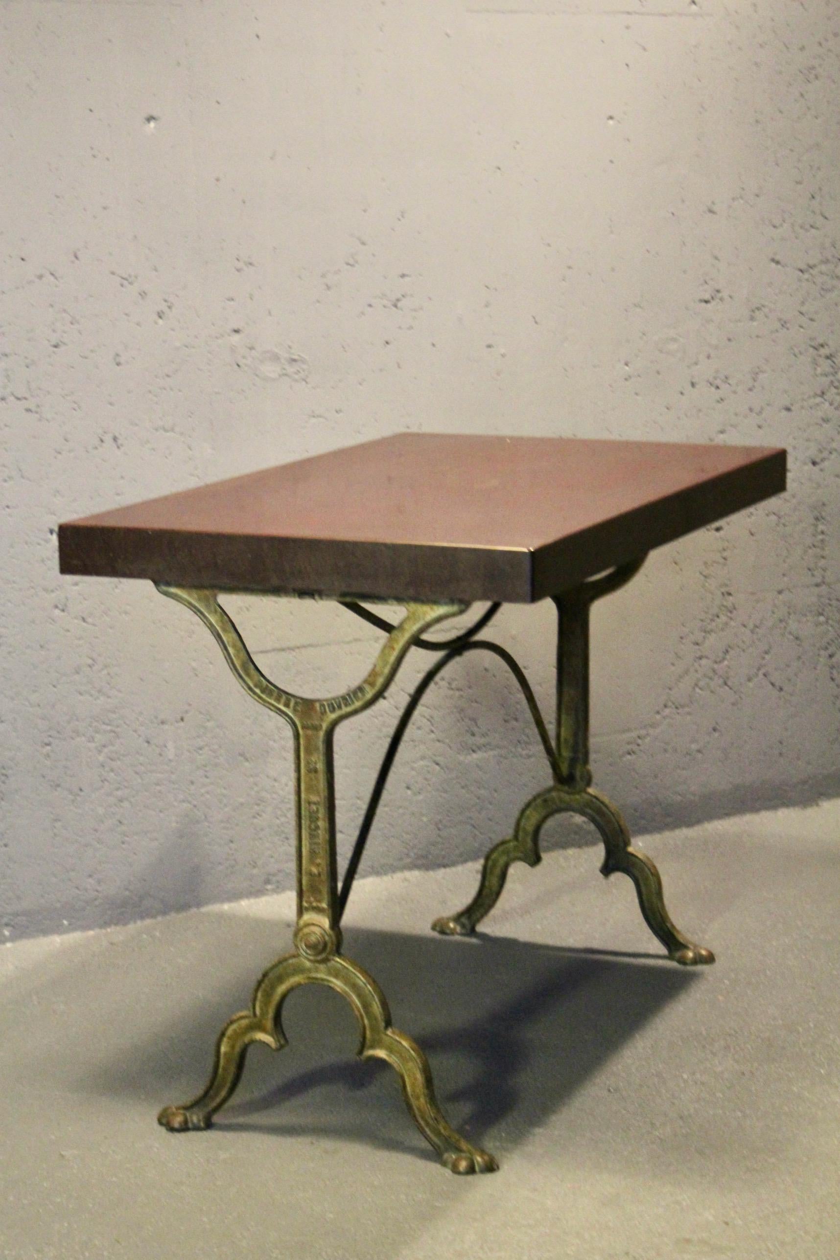 bistro table with a signed design, Bakelite top, and cast iron base For Sale 1