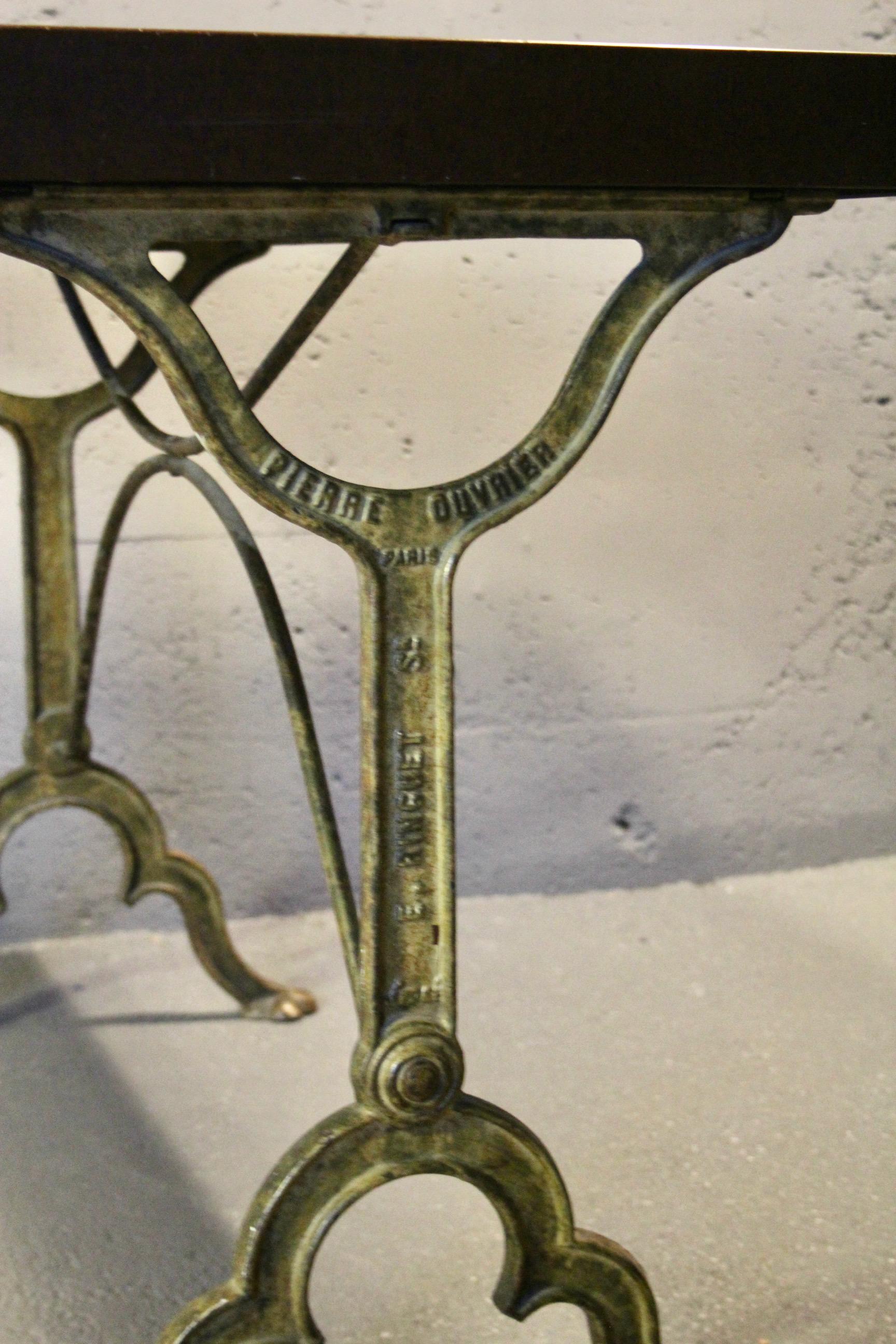 bistro table with a signed design, Bakelite top, and cast iron base For Sale 4