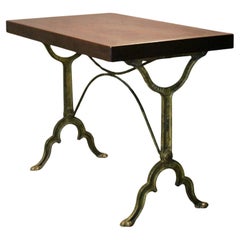 bistro table with a signed design, Bakelite top, and cast iron base
