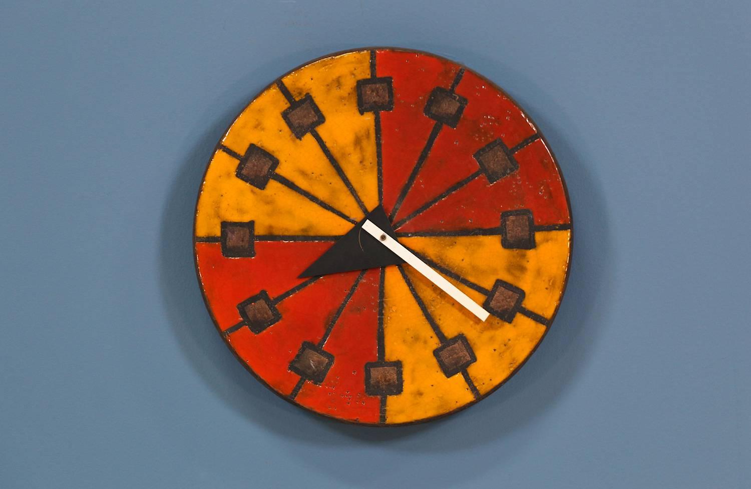 Mid Century modern ceramic clock designed by Bitossi & George Nelson for Howard Miller & Raymor circa 1950’s. This iconic collaboration is part of the “Meridian” collection and features a ceramic glazed stoneware face with earthy colors designed by