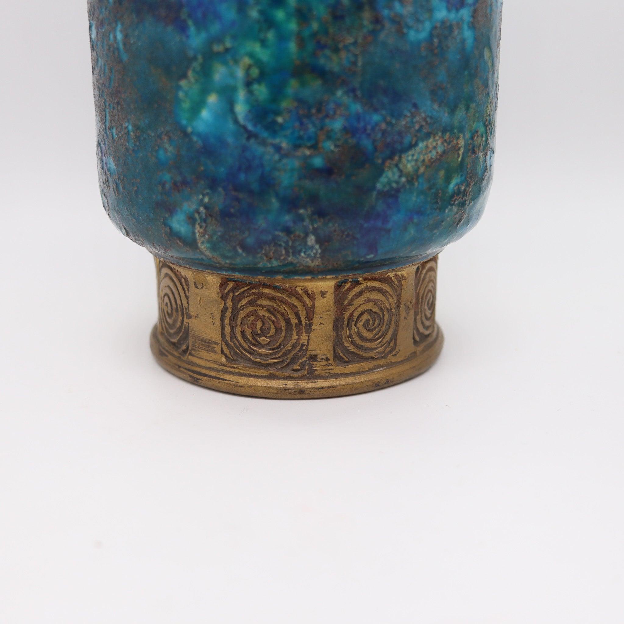 A tall blue glazed vase designed by Bitossi for Rosenthal Netter.

This is a Bitossi vase crafted in Florence Italy in blue glazed ceramic and gold. This is the larger scale vase with perfect proportions, glazed in a textured blue with hints of
