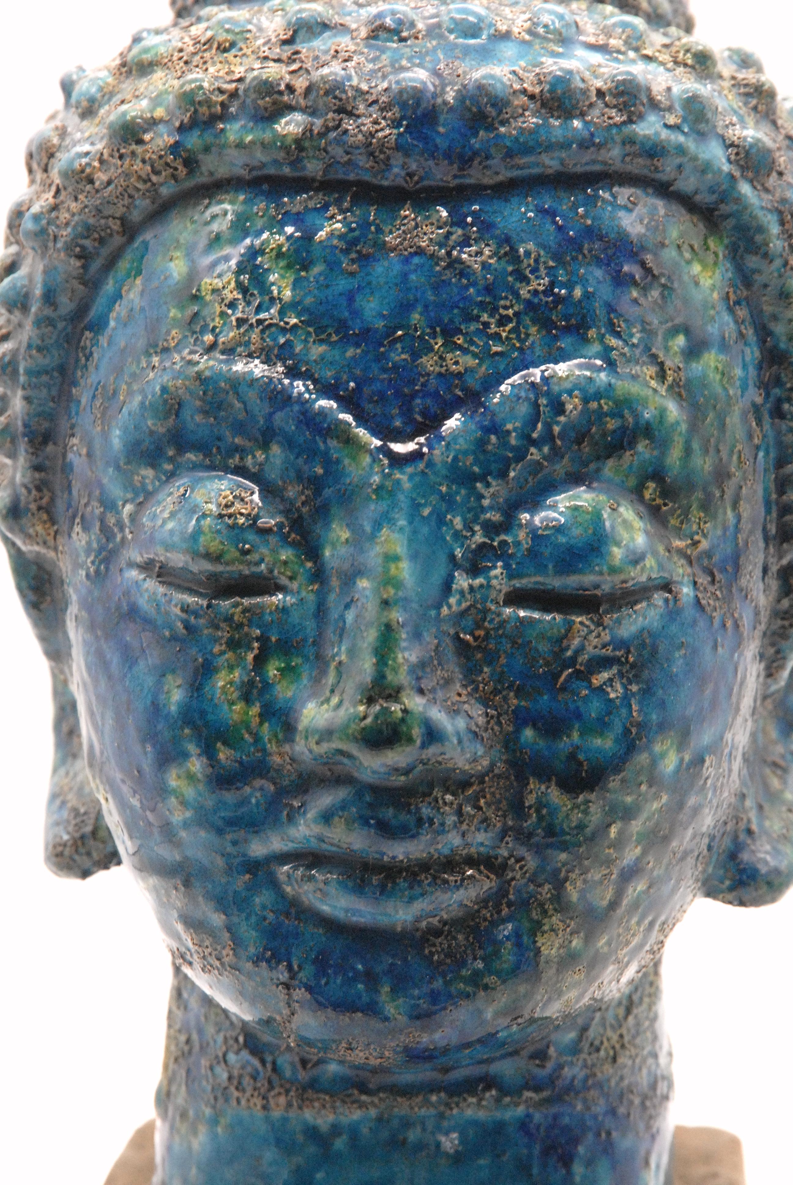A stunning Aldo Londi designed Buddha head in the 'Cinese' [Chinese] glaze, replicating ancient bronze pieces that have been on the ocean floor for millennia. The glaze is fragile and this piece is in excellent order.