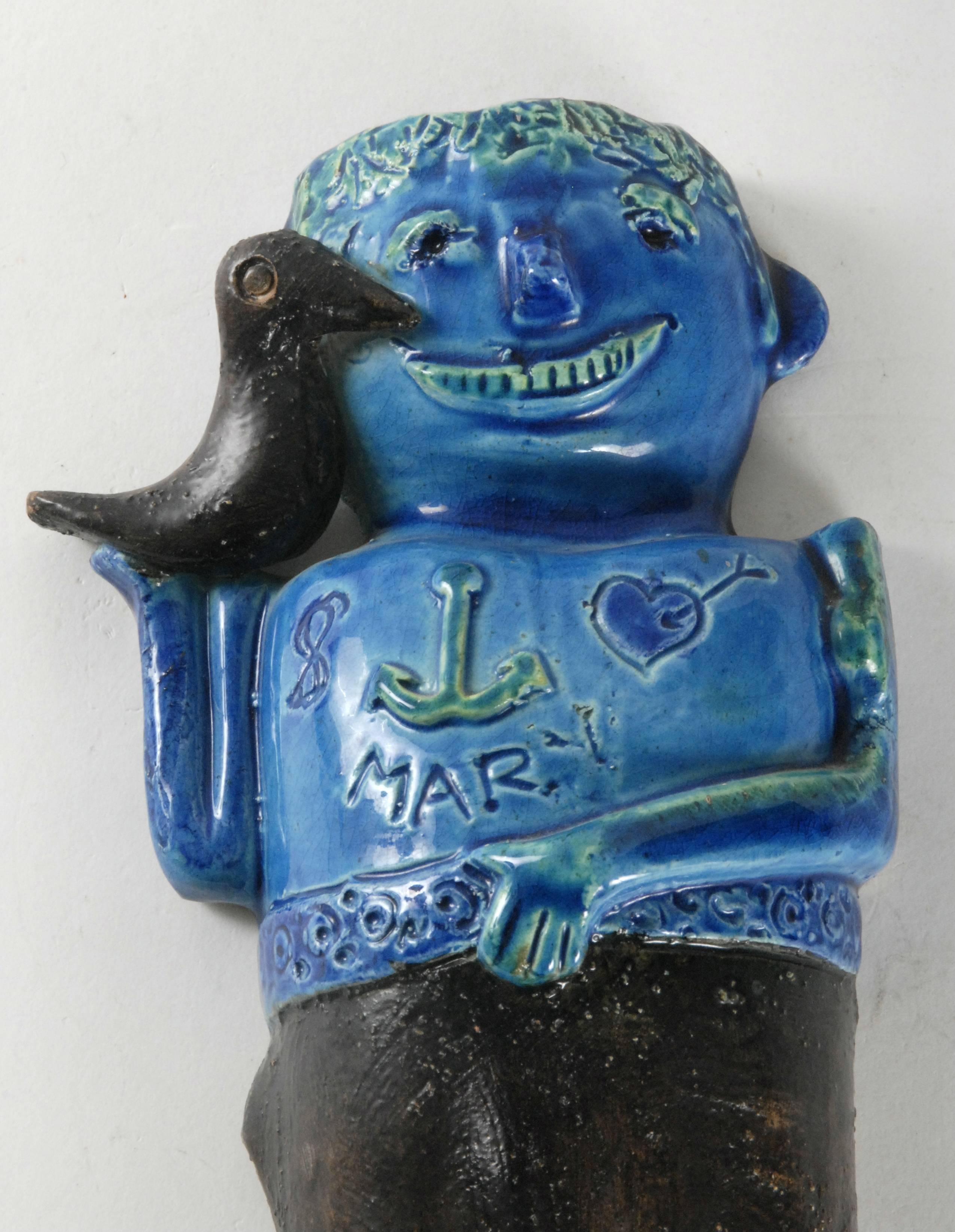 An Aldo Londi for Bitossi designed wall hanging of a sailor with a bird on his shoulder and an anchor and 'Mary' with a heart and arrow on his chest.
 