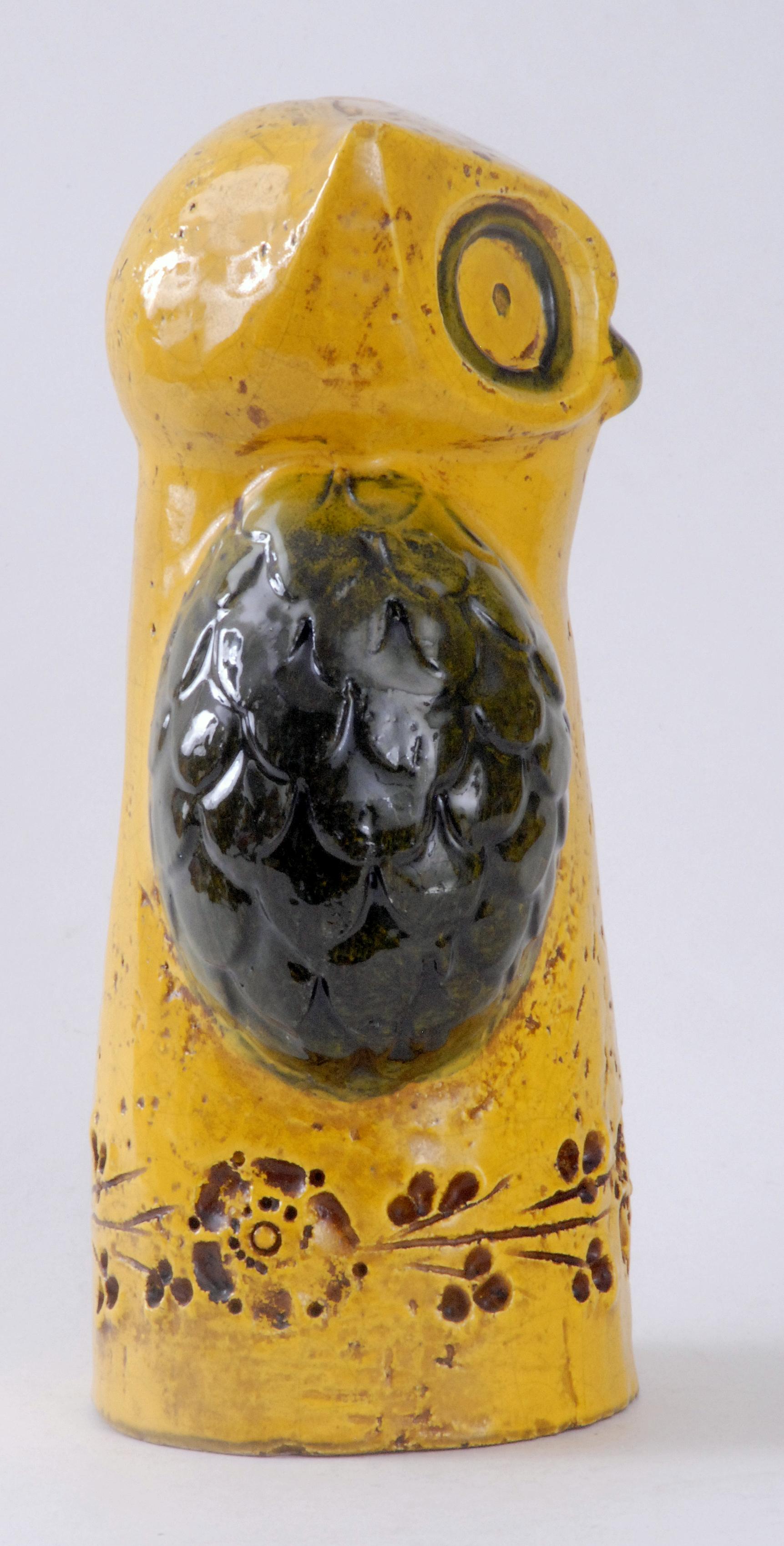 A yellow owl designed by Aldo Londi in the 1960s with impressed stylized flower motifs around the bottom.
Retains the Rosenthal Netter label inside the base.
