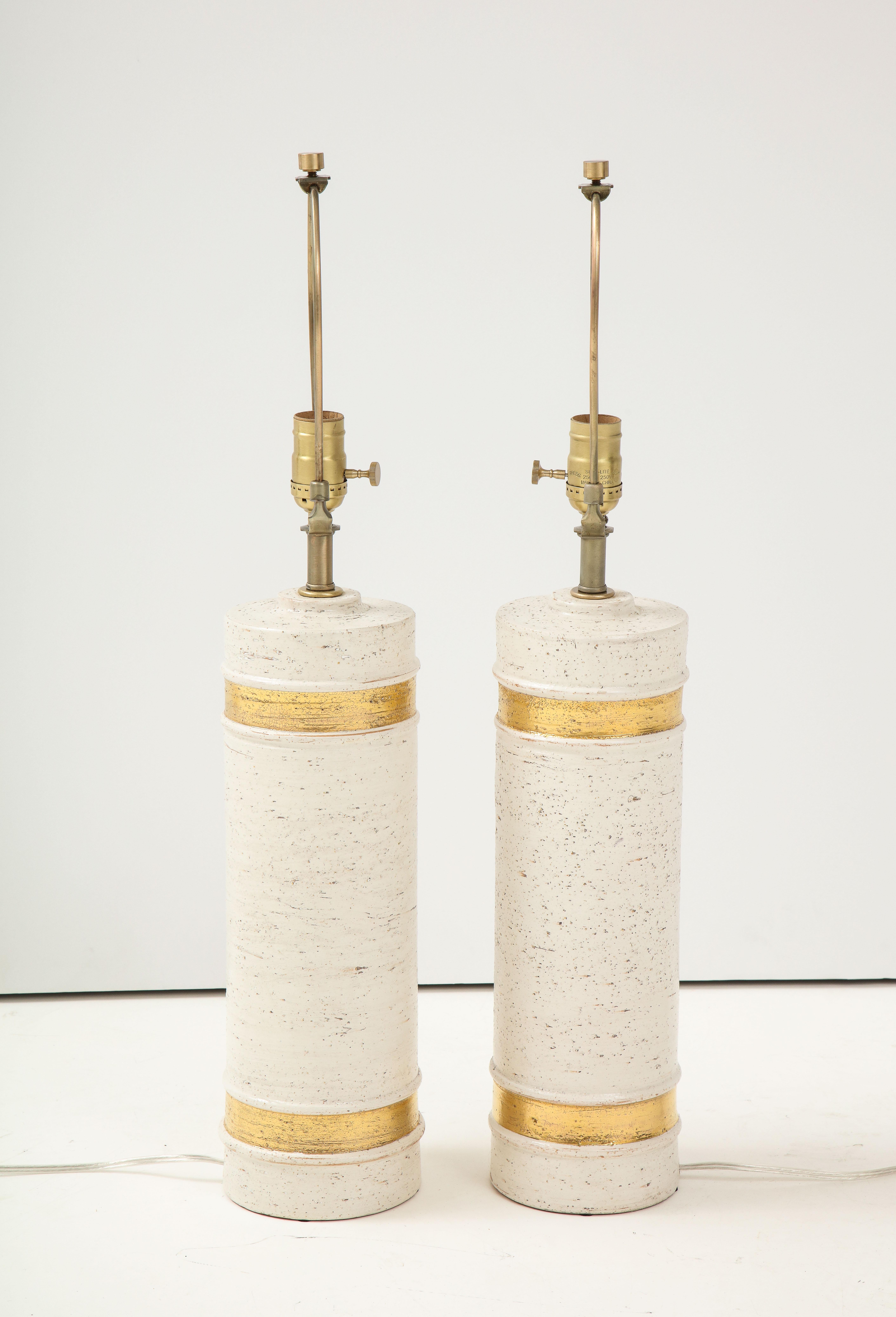 Pair of Scandinavian Modern birch tree glazed lamps with 22kt gold glaze bands, rewired for use in the USA.
100W max.