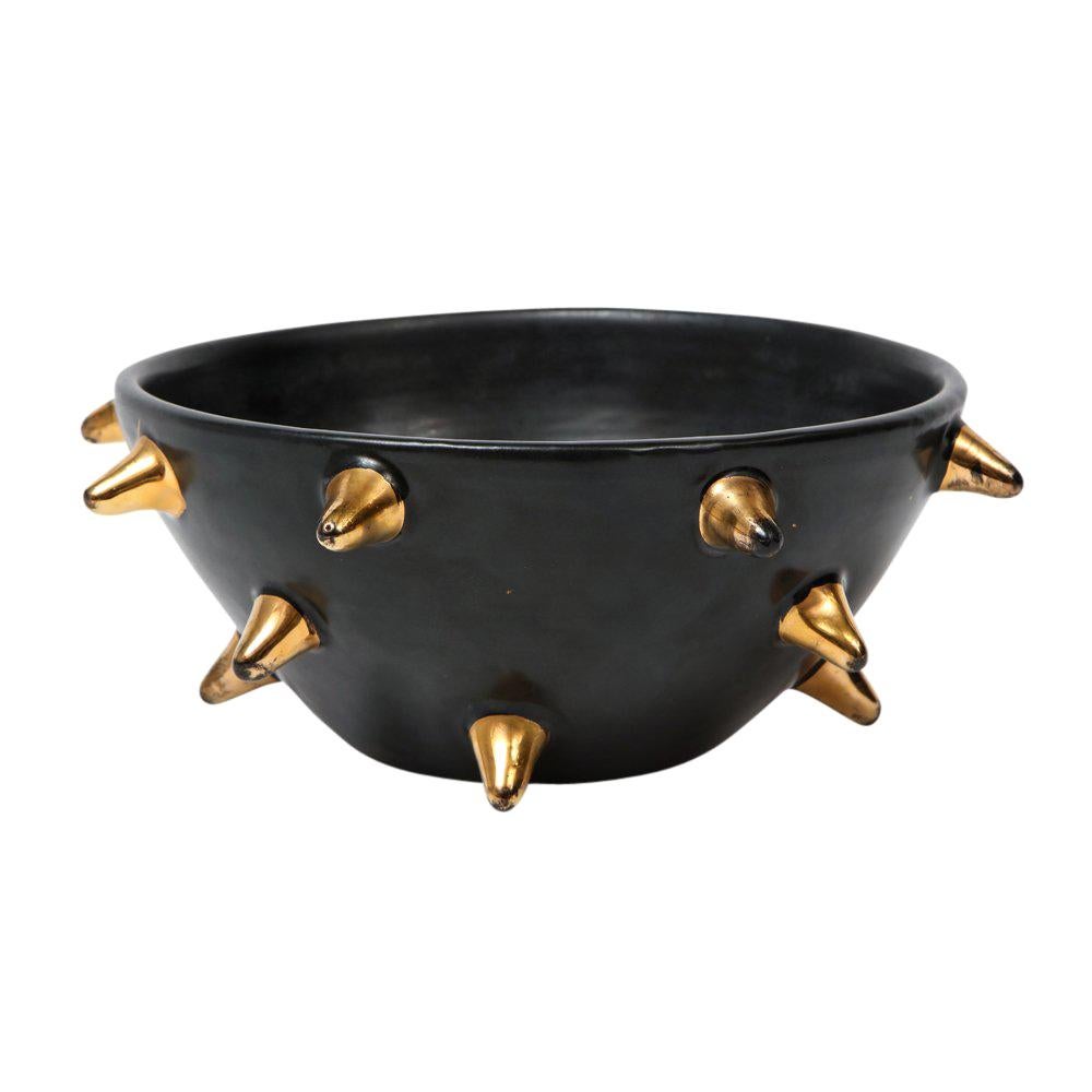 Bitossi bowl, ceramic, black with gold spikes, signed. Small to medium scale bowl in black glaze decorated with applied gold spikes. Signed on the underside: 95/269 B, Italy. Some minor wear and glaze loss to the gold spikes.