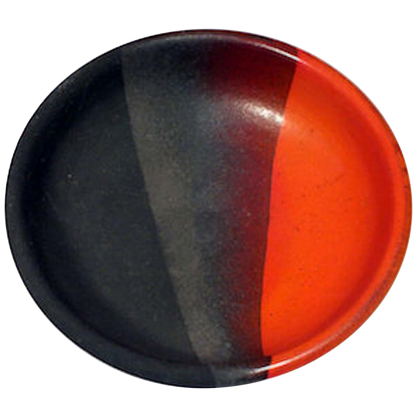 Bitossi bowl, ceramic, orange, matte black, signed. Small to medium scale glazed bowl decorated with 3 segments of color and texture, in semi-gloss and matte finishes. Signed 8165 B Italy on underside of the bowl.