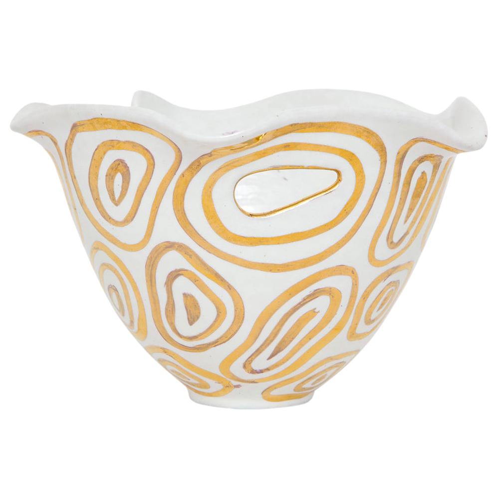 Bitossi bowl, white and gold, abstract, signed. Small to medium scale bowl with gold abstract glaze over white with two tiny cutout handles near the top edge. Organic, wavy free edge lip. Tiny black spec visible in photos 2 and 3. Signed on the