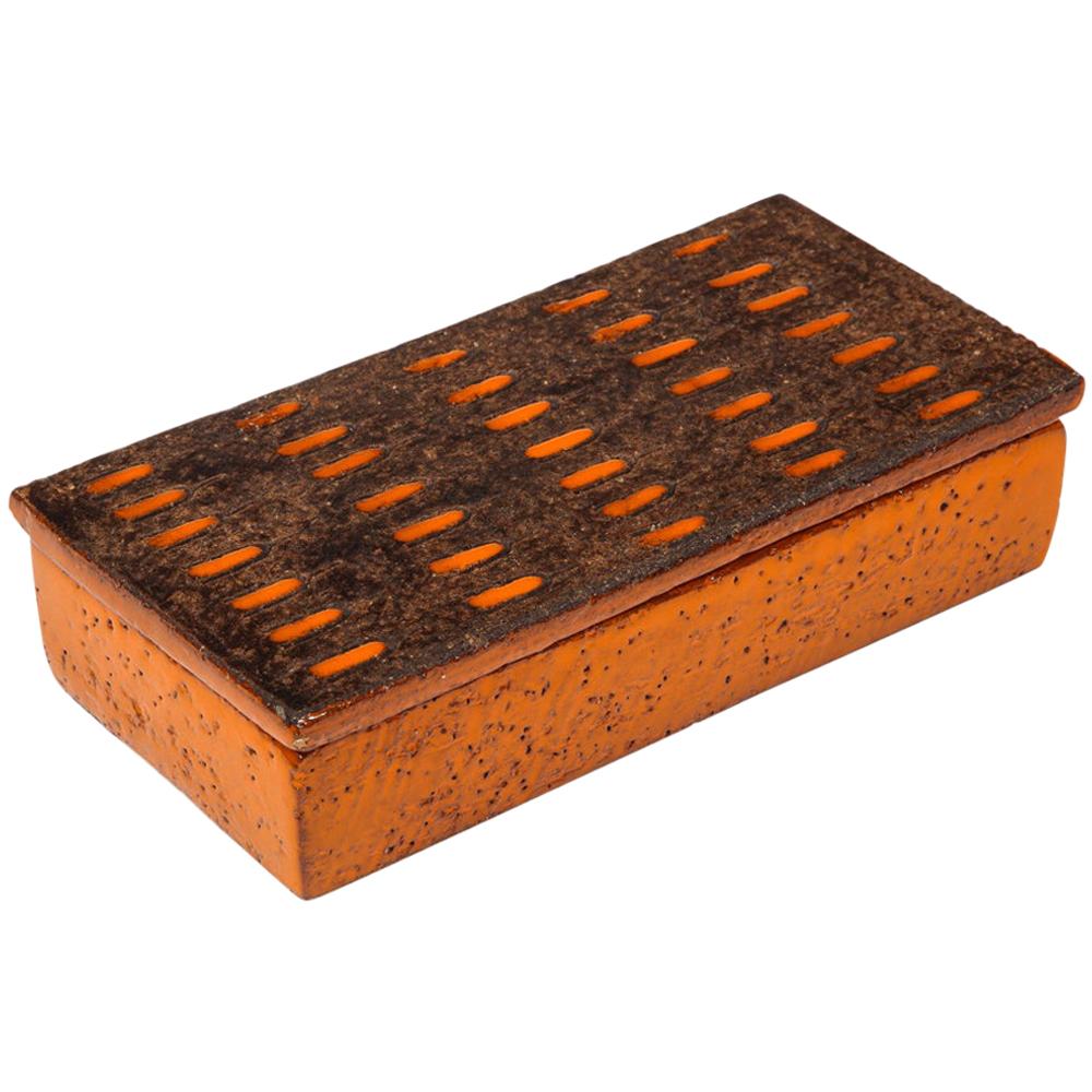 Bitossi box, ceramic, orange and matte brown, signed. Small scale box having a raw clay lid hash mark incising and decorated with an orange glazed pill pattern. Signed on the underside: 40/9 Italy.

