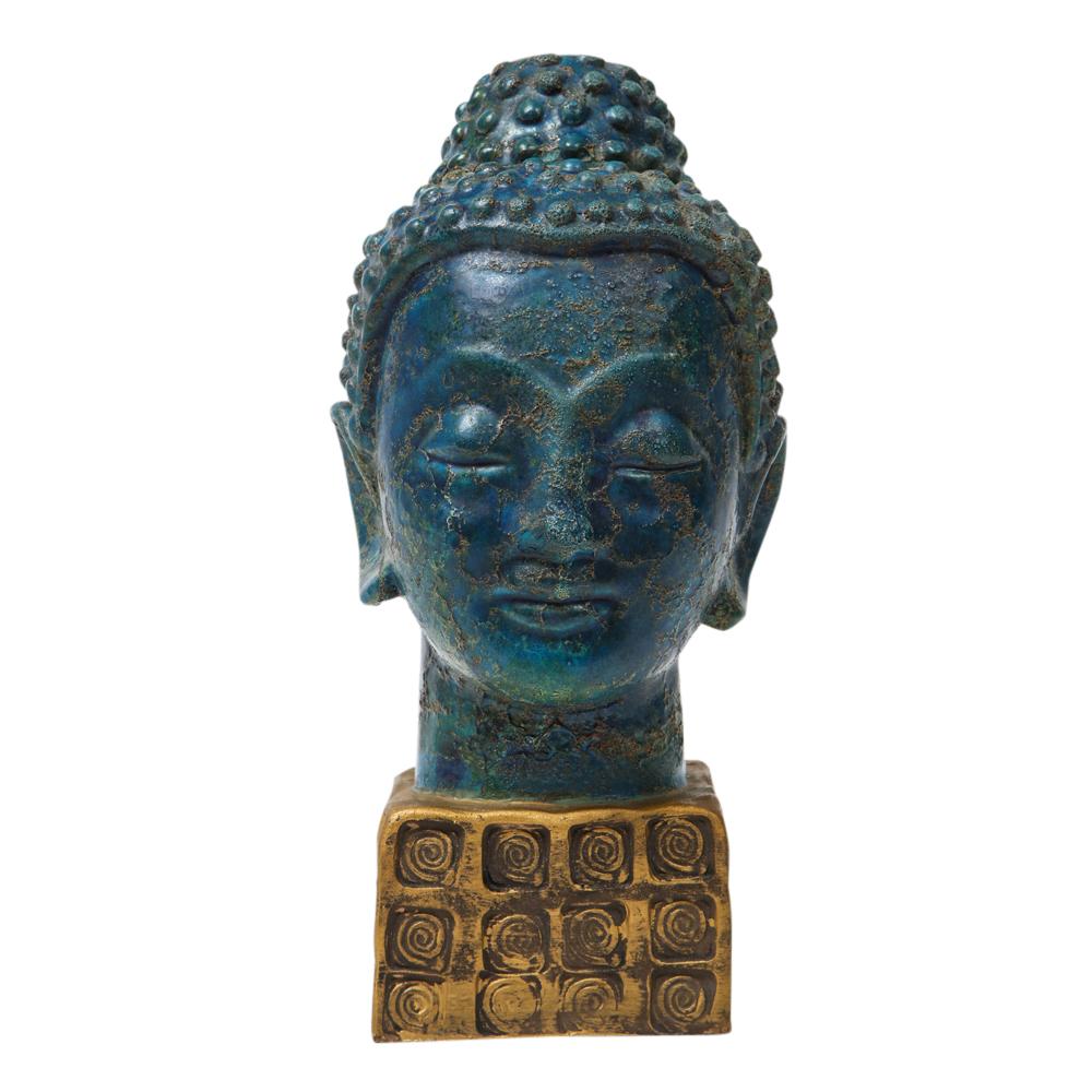 Bitossi Buddha, ceramic blue gold. The Buddha is glazed in a textured blue and green and mounted on a gilt glazed base which features a pattern of impressed spiral circles. The 