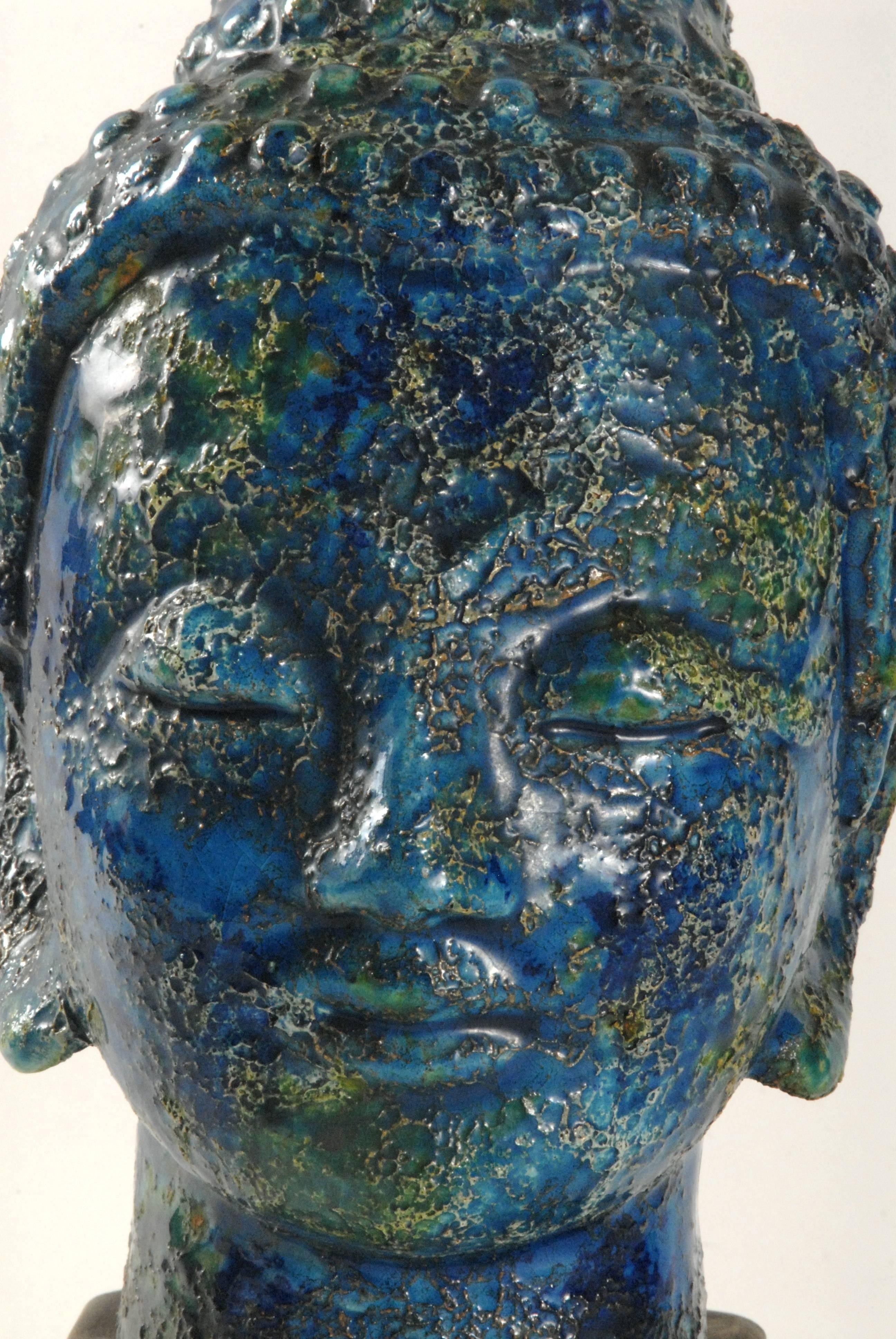 A wonderful Aldo Londi for Bitossi Buddha's head with a blue 'Cinese' glaze replicating ancient bronzes that were recovered from the depths of the world's oceans. Stunning vibrant glaze in near pristine condition.