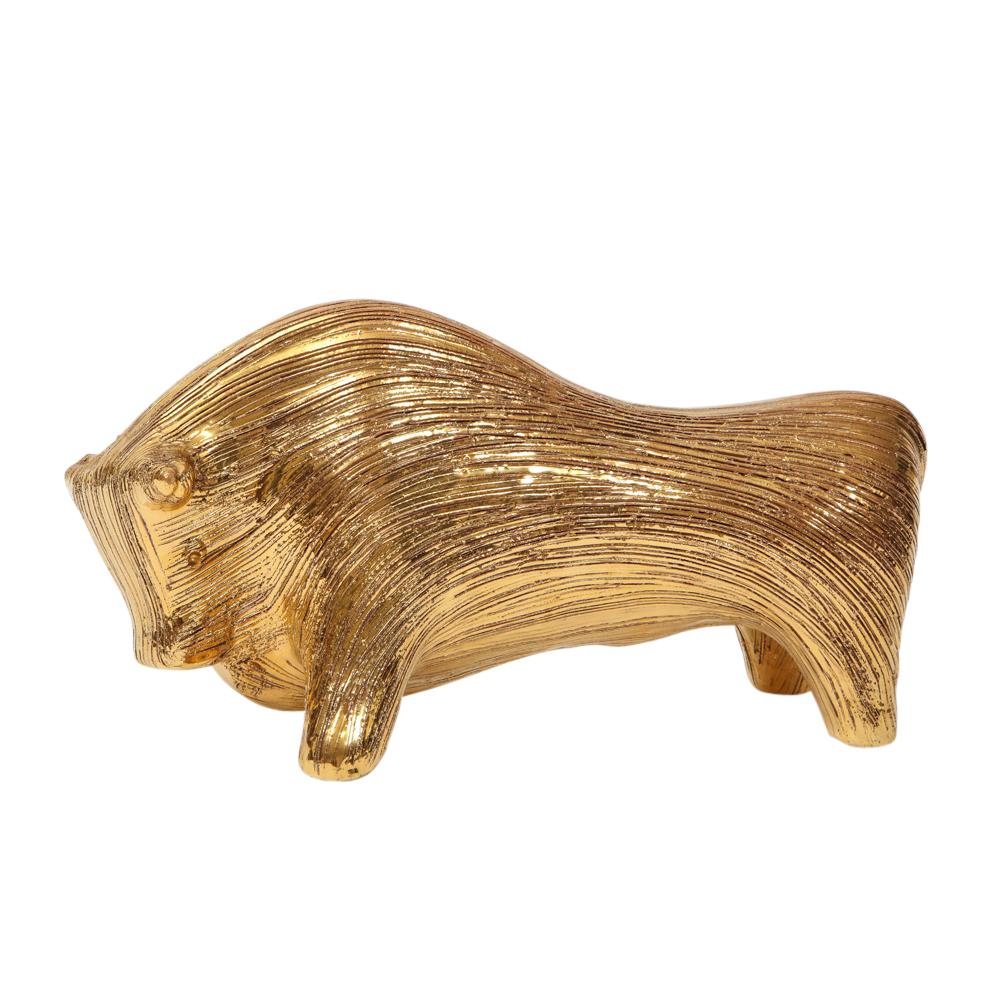 Bitossi bull, ceramic brushed gold. Aldo Londi designed, medium scale stylized bull in textured brushed gold glaze. The Bitossi factory mixed 24-karat gold to achieve the luster to their gold glazes.